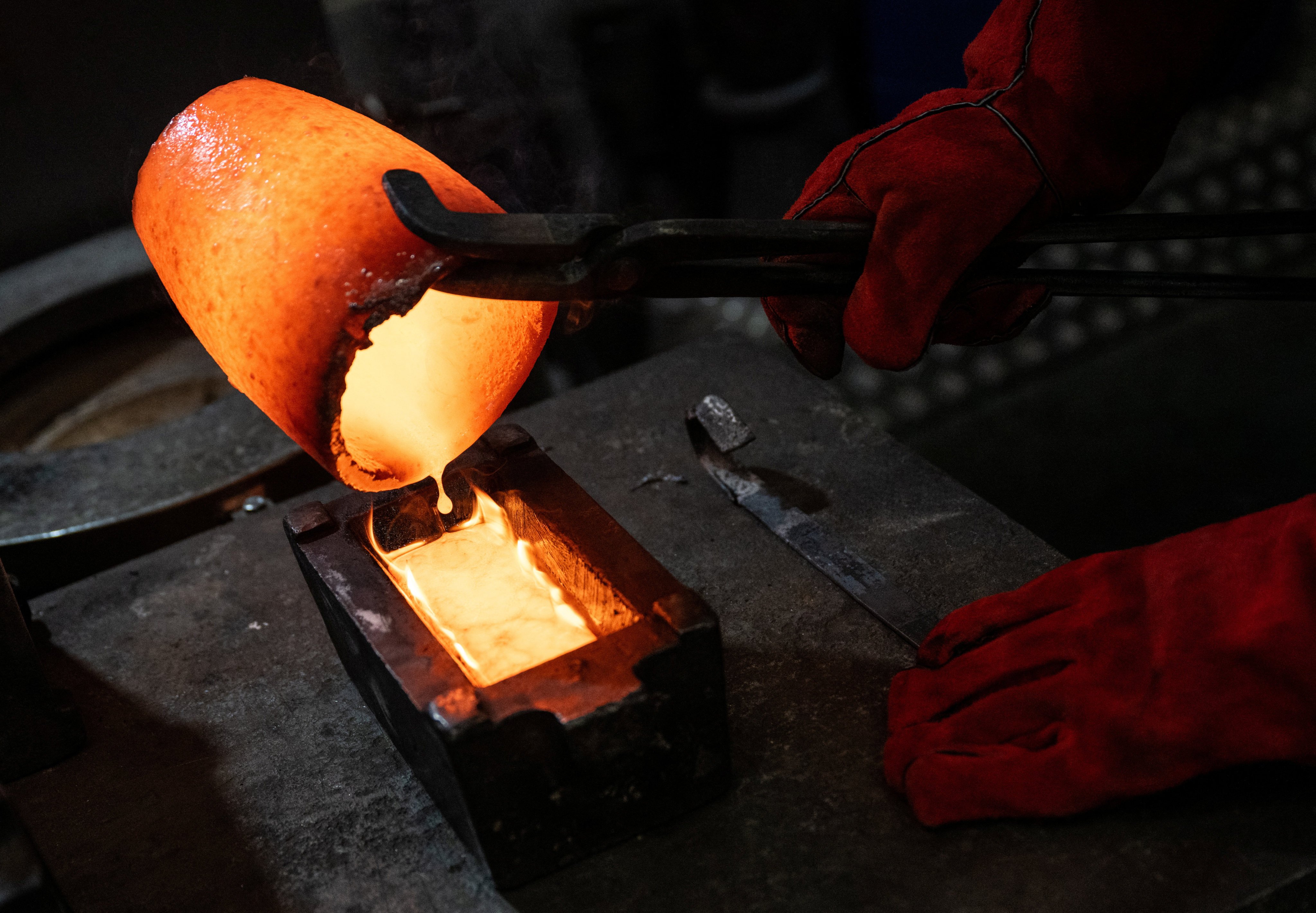 Melted gold coins and jewellery are poured into a casting mould at Baird & Co., the United Kingdom’s largest independent gold trader and refinery, in London on April 22. Photo: Reuters