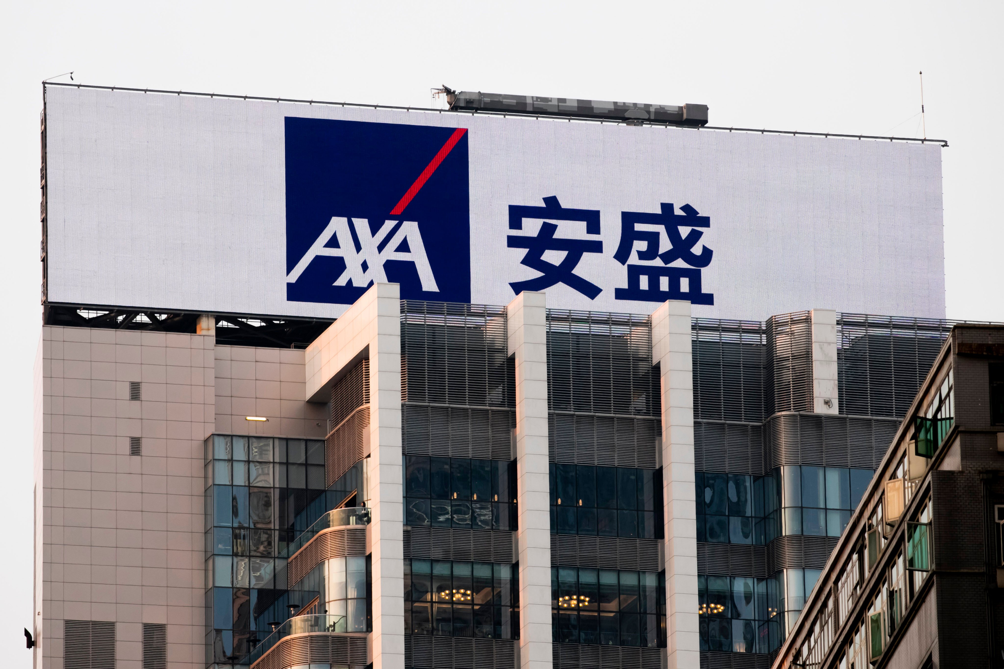 An ad for AXA is seen at the top of a building in Hong Kong’s financial centre, February 27, 2018. Photo: IP3/Getty Images