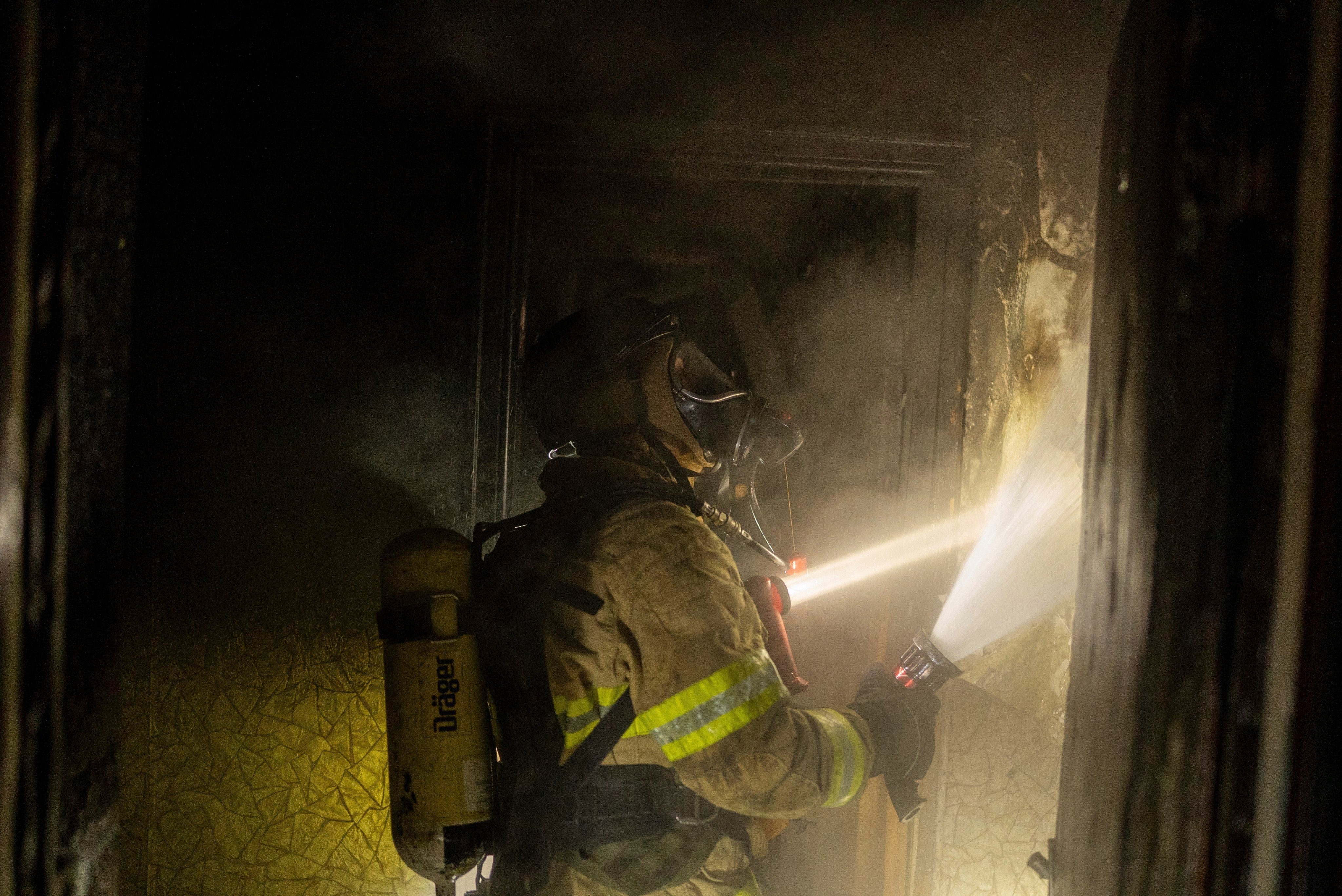Firefighters extinguish a fire in a residential building damaged by a Russian attack in Kyiv on Saturday. Photo: AP