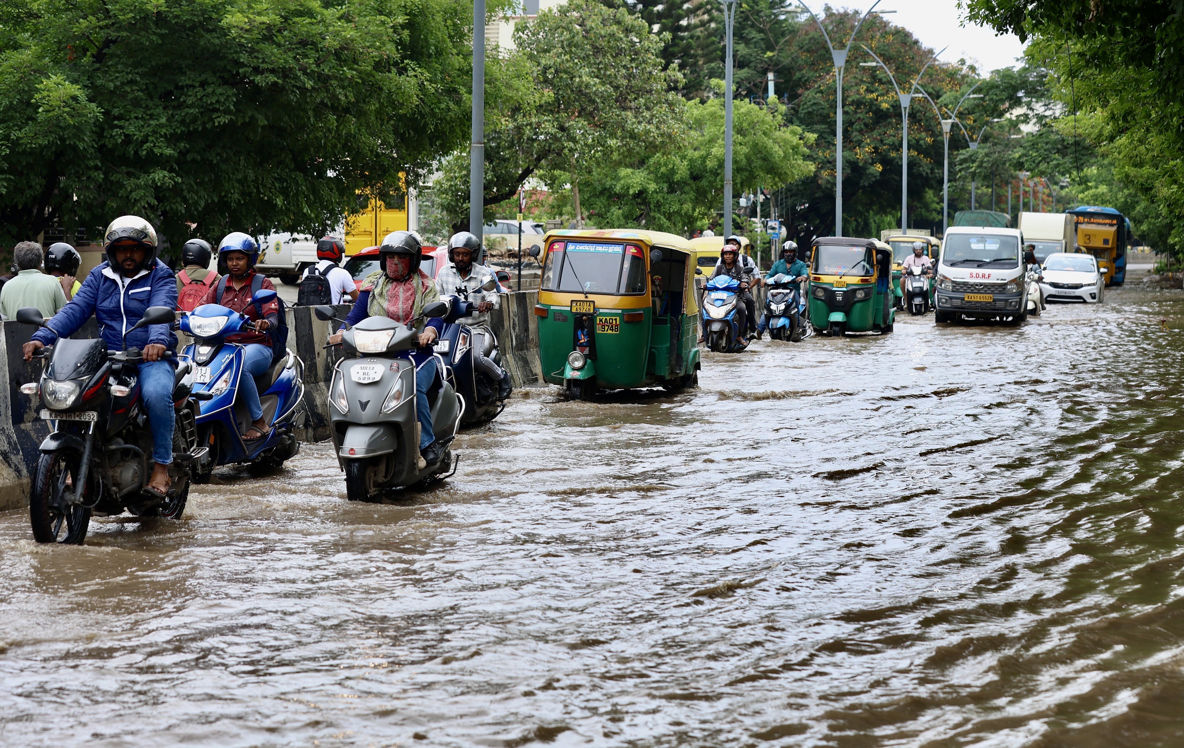 Motorists drive through a waterlogged street following heavy rainfall in Bengaluru, India, on Tuesday. Photo: EPA-EFE