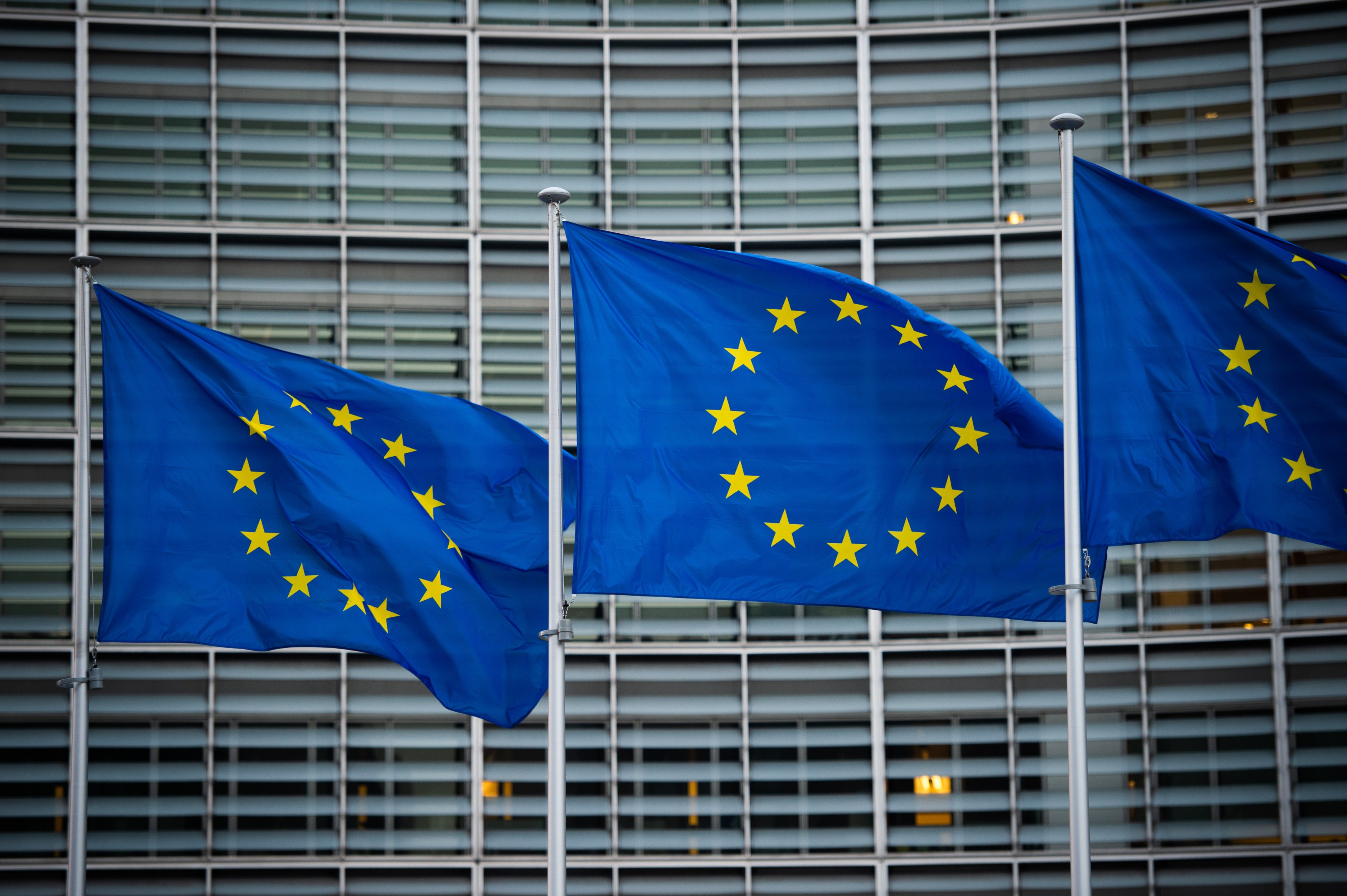 Flags of the European Union wave in the wind in front of the Berlaymont building of the European Commission.  Photo: dpa