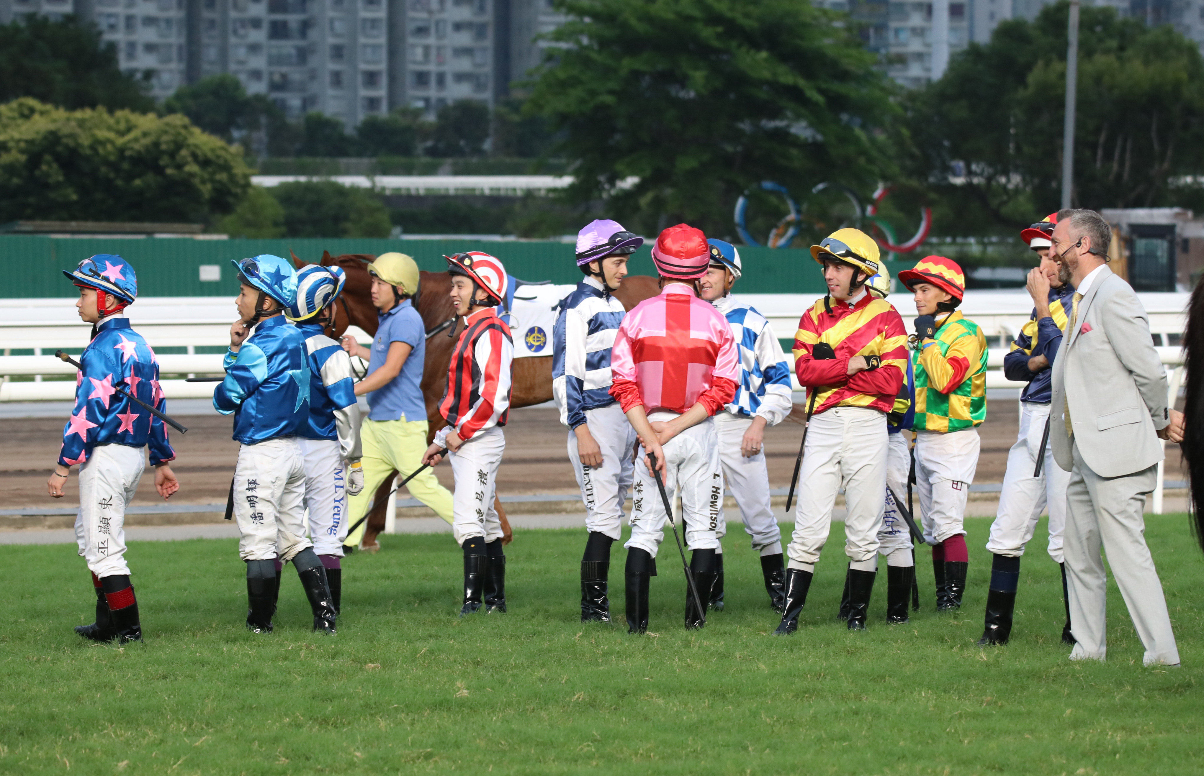 Jockeys mill around during delays to the start of race 10 at Sha Tin on Sunday. Photos: Kenneth Chan