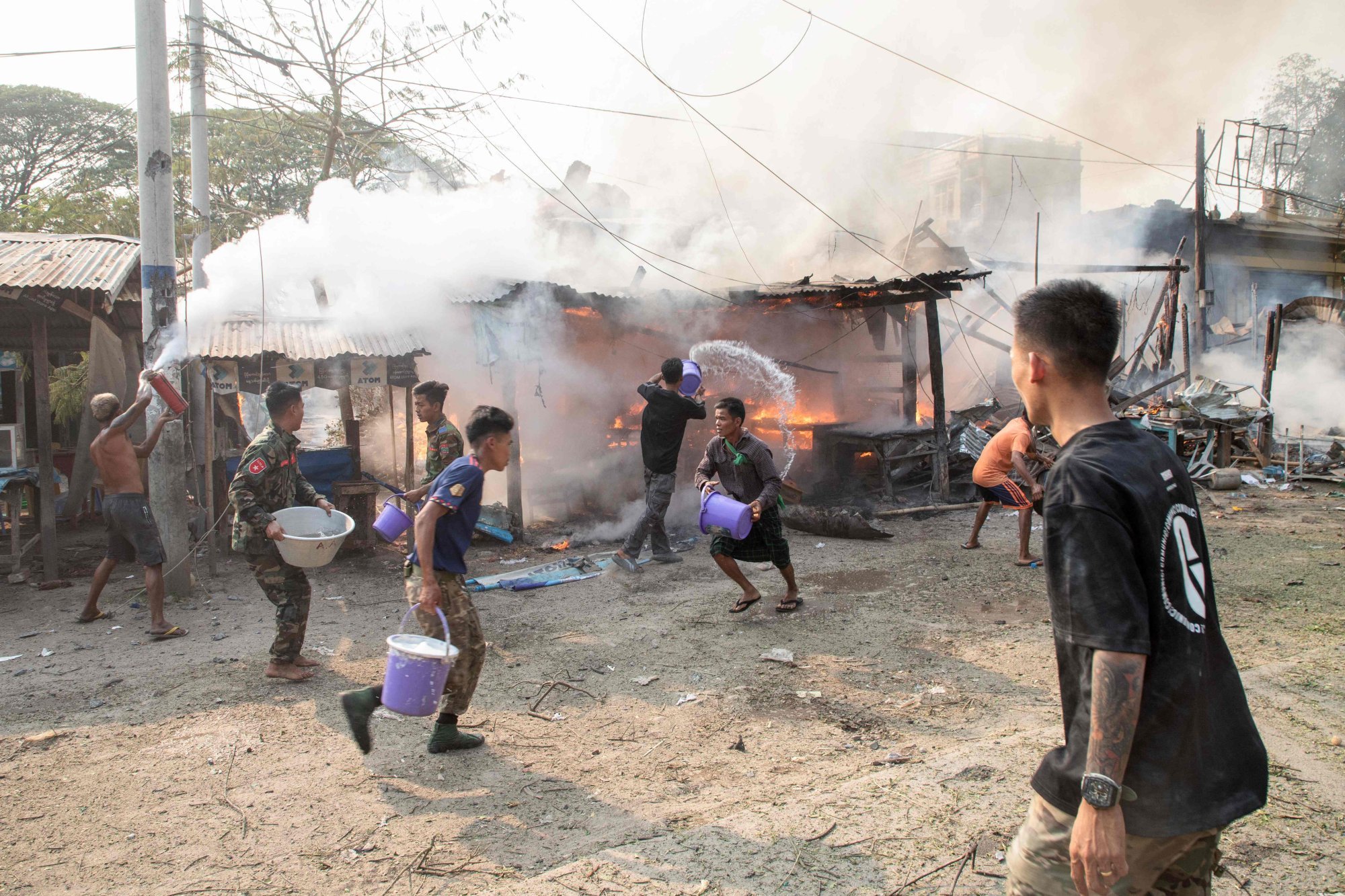 People trying to extinguish fires following aerial bombardments by Myanmar’s military in Singu Township in central Myanmar’s Mandalay Region, on March 14. Photo: AFP People trying to extinguish fires following aerial bombardments by Myanmar’s military in Singu Township in central Myanmar’s Mandalay Region, on March 14. Photo: AFP