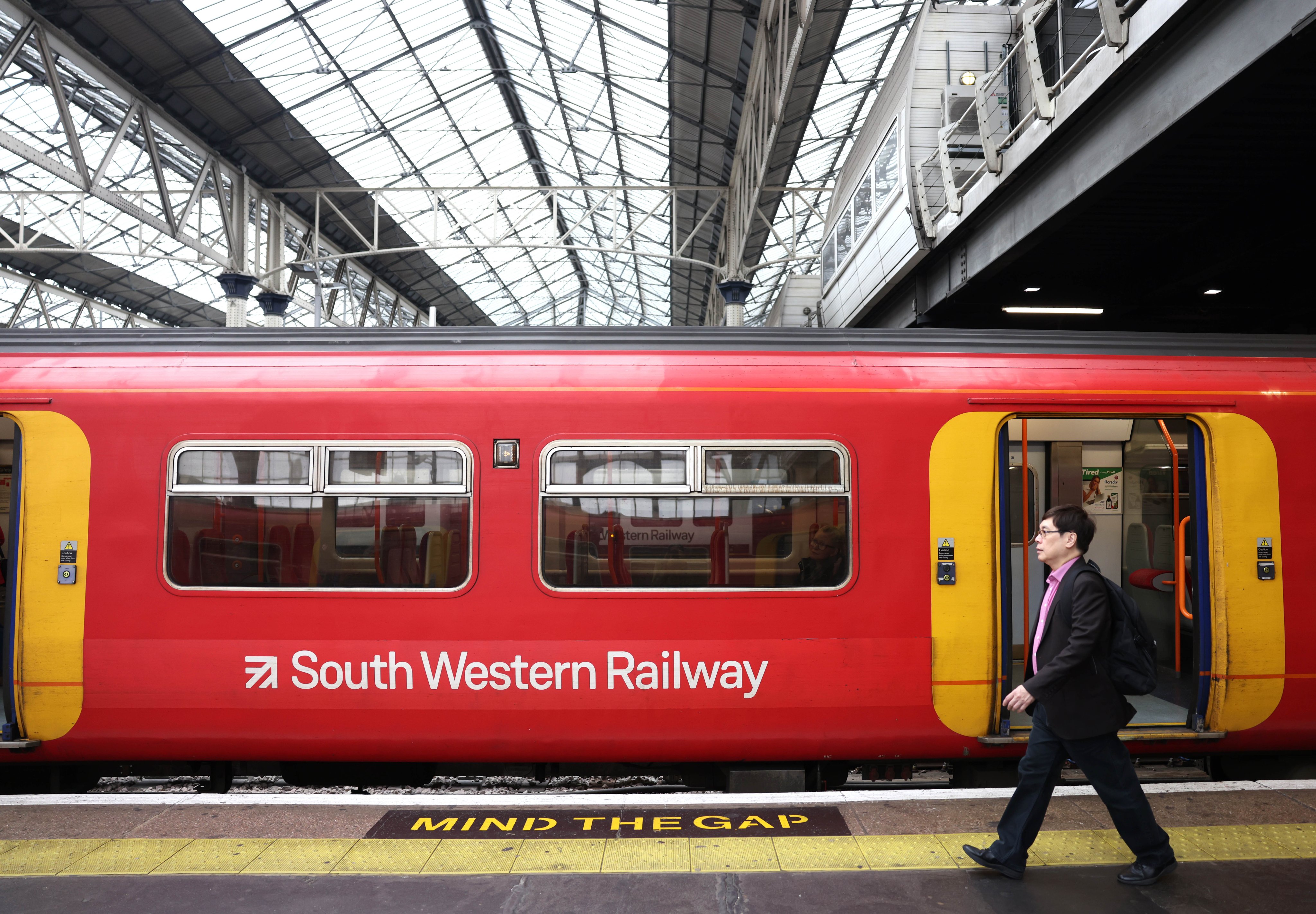 Passengers get on a South Western Railway service at a station in London, Britain, on Saturday. Photo: EPA-EFE