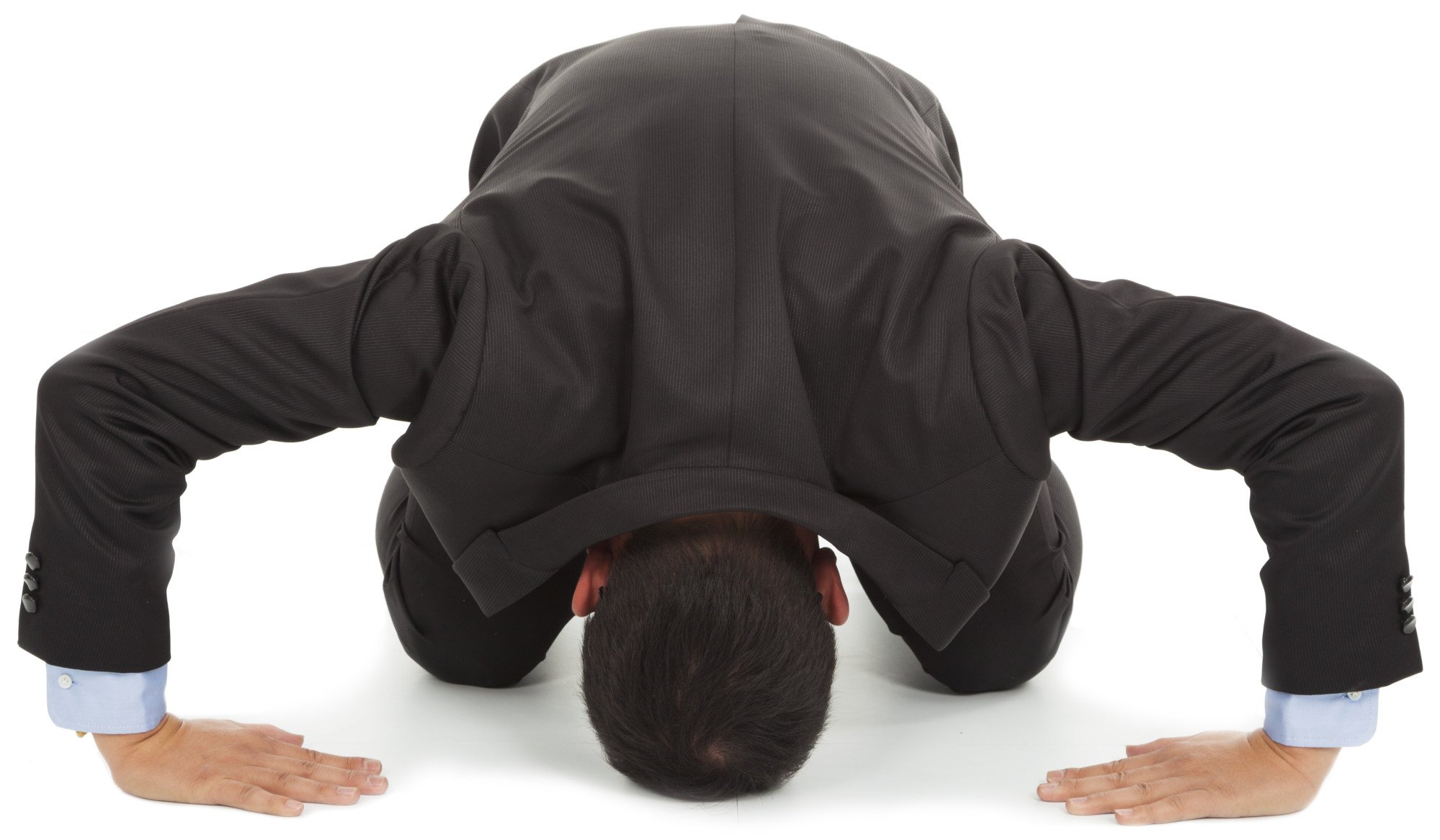 A Japanese businessman apologising by performing the dogeza. Photo: Shutterstock