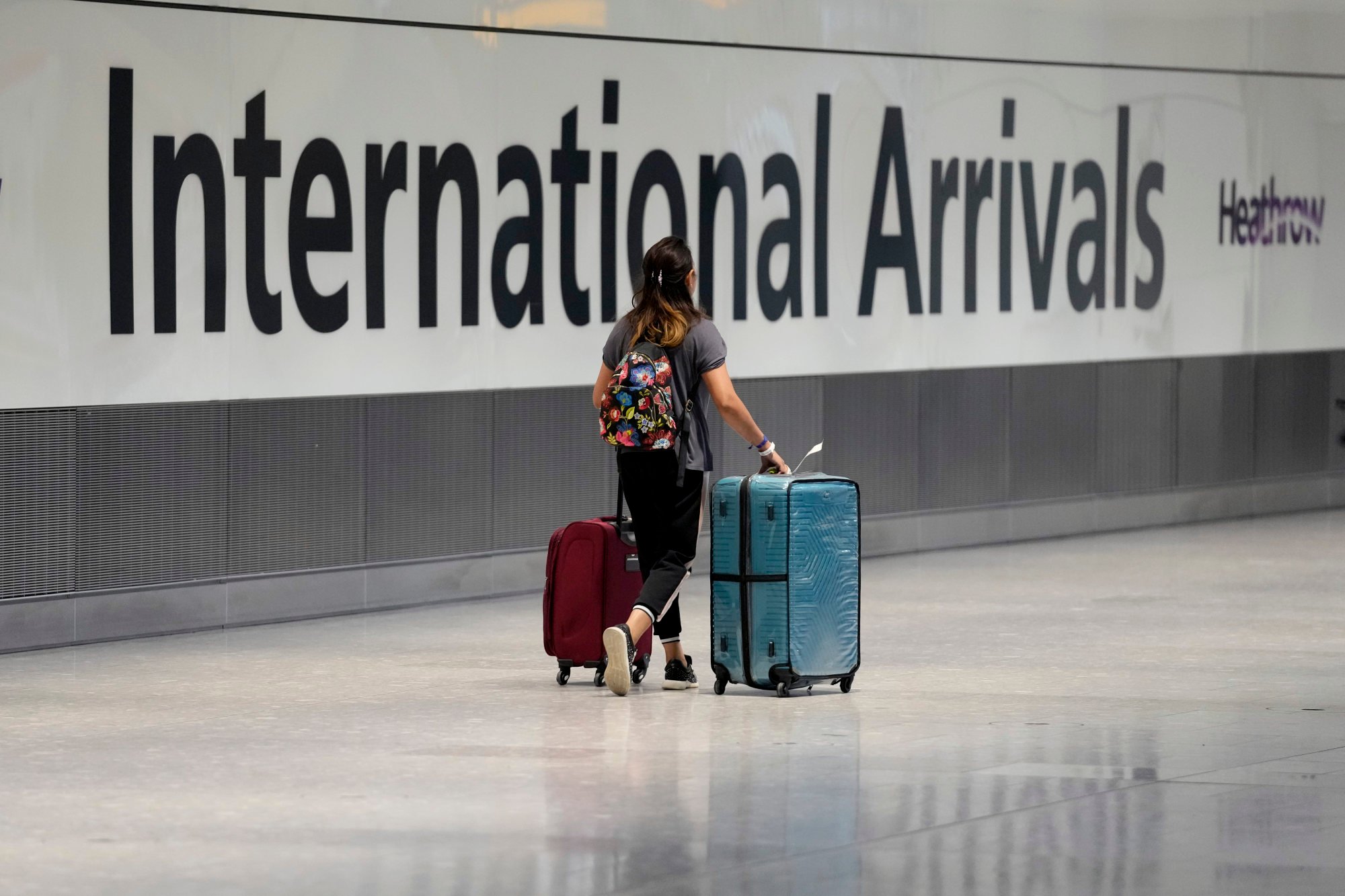 A passenger arrives after disembarking from a flight at Heathrow Airport in London. Photo: AP A passenger arrives after disembarking from a flight at Heathrow Airport in London. Photo: AP