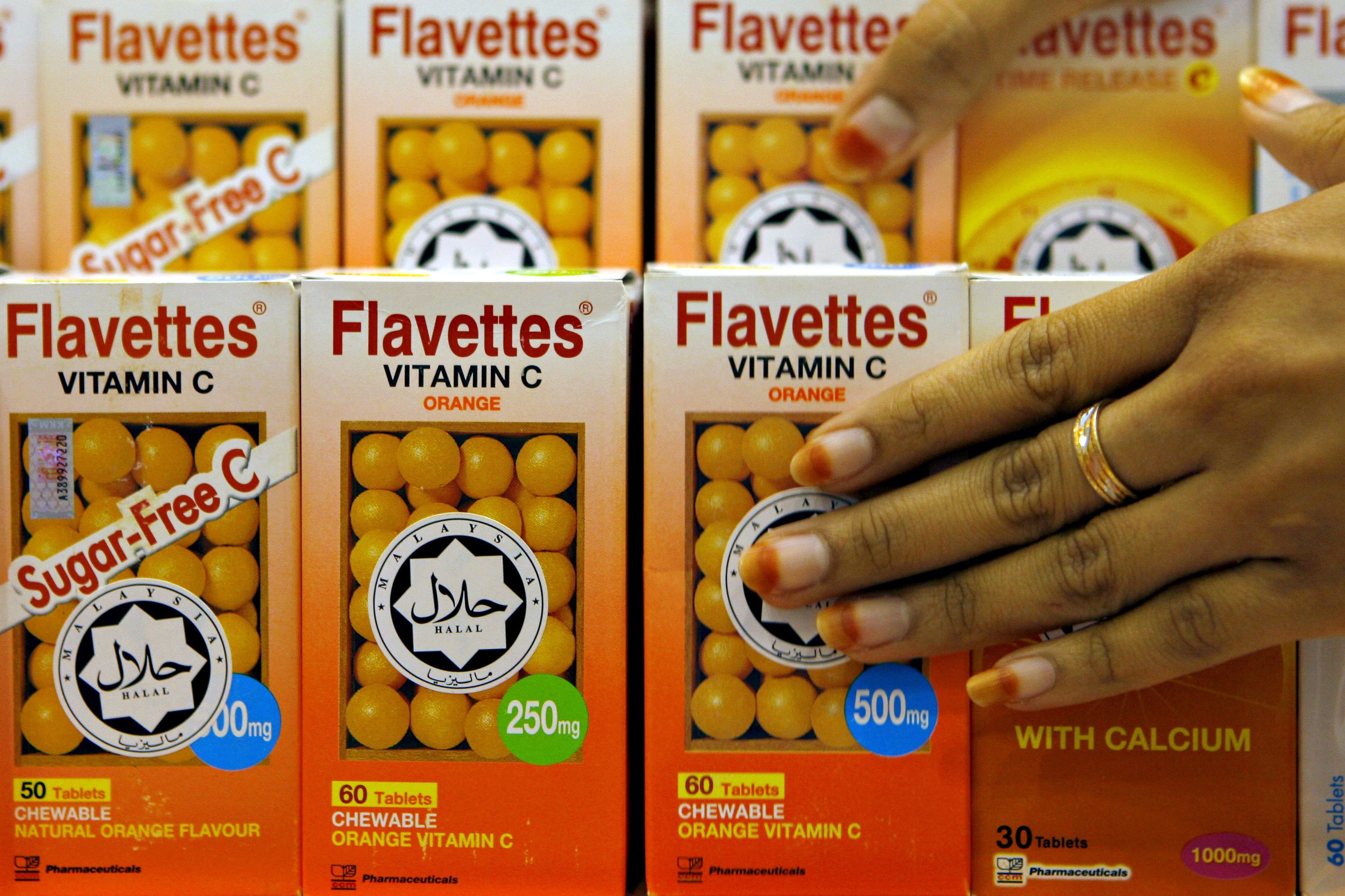 Vitamin C bottles are seen in Malaysia carrying a halal decal, assuring customers the product was prepared according to proper Muslim rites. Photo: AFP