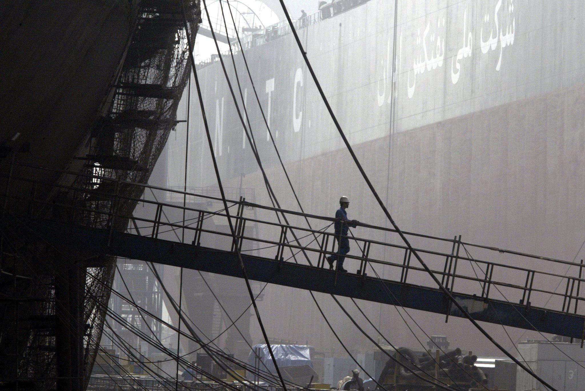 A worker walks off a vessel being built in a shipyard in Dalian, China’s Liaoning province, in 2004. China has become a shipbuilding powerhouse in recent decades. Photo: EPA-EFE