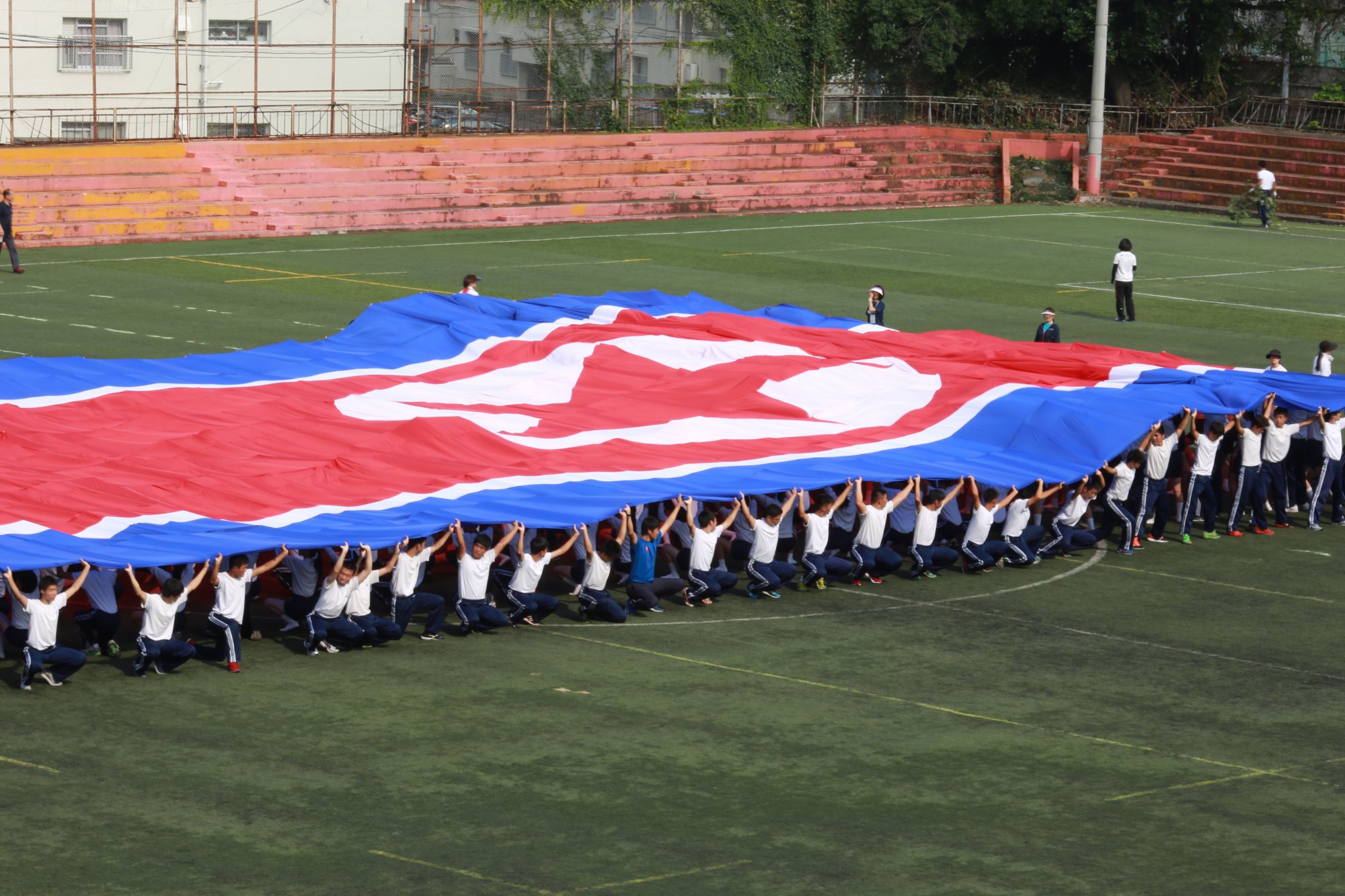 A student flag team practises a performance waving red, white and blue banners to form the North Korea national flag at a Korean high school in Tokyo in 2017. Photo: AP A student flag team practises a performance waving red, white and blue banners to form the North Korea national flag at a Korean high school in Tokyo in 2017. Photo: AP