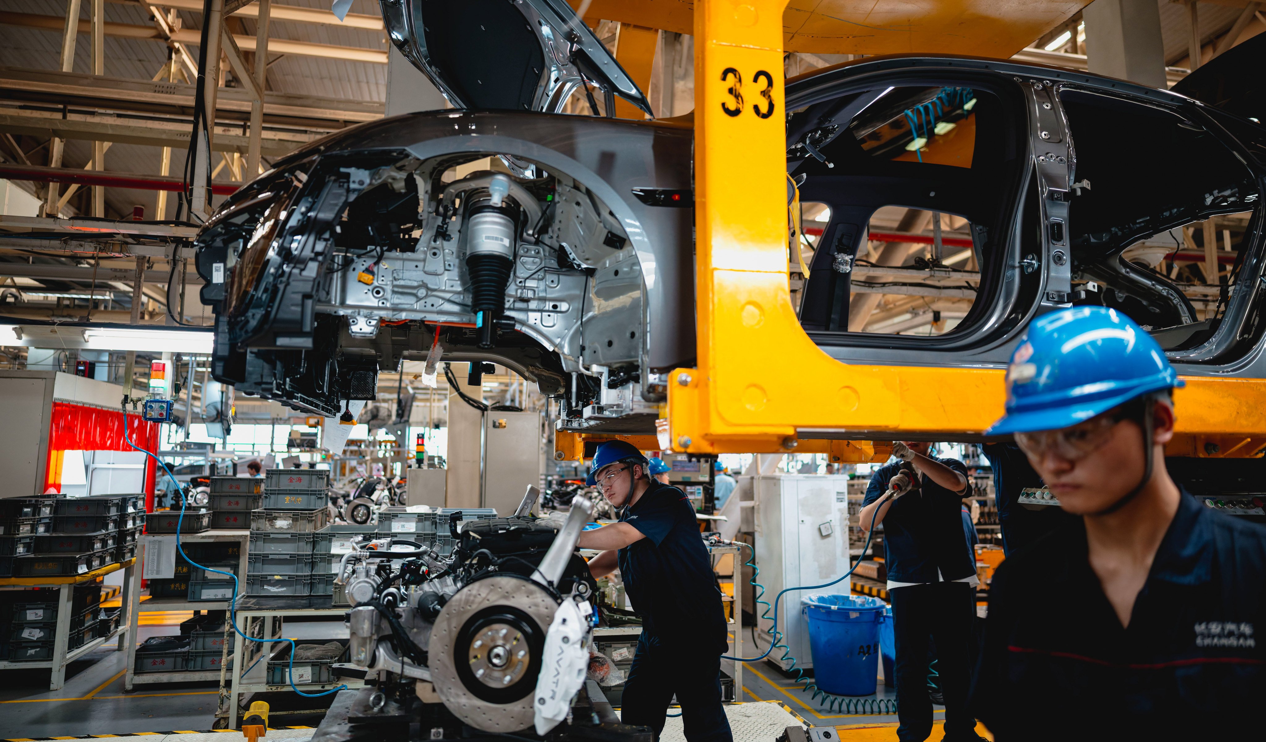 Laborers work on an assembly line in the AVATR EV factory in Chongqing, China. Photo: EPA-EFE