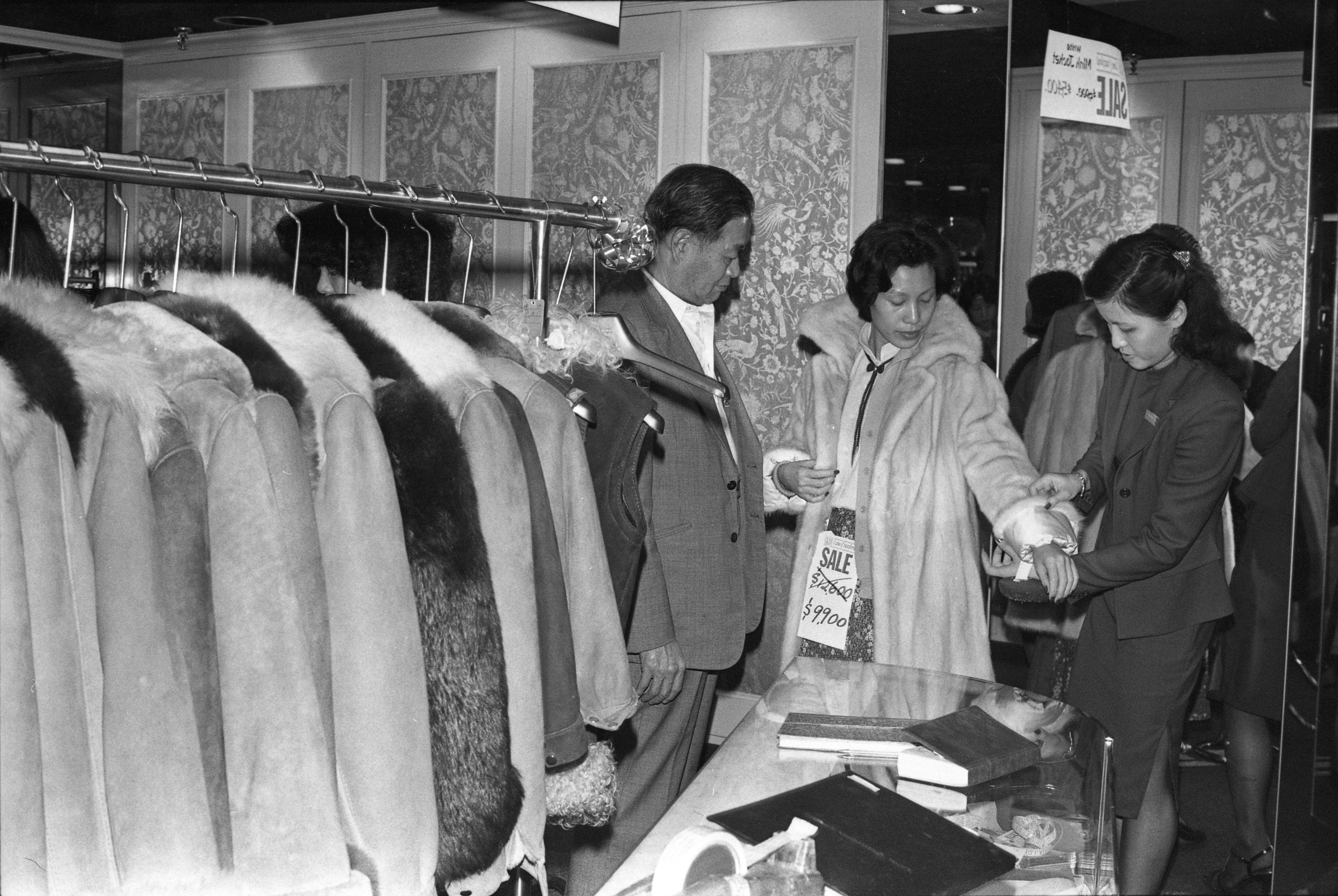 A woman tries on a fur coat in the Hong Kong winter of 1979. Photo: SCMP Archives