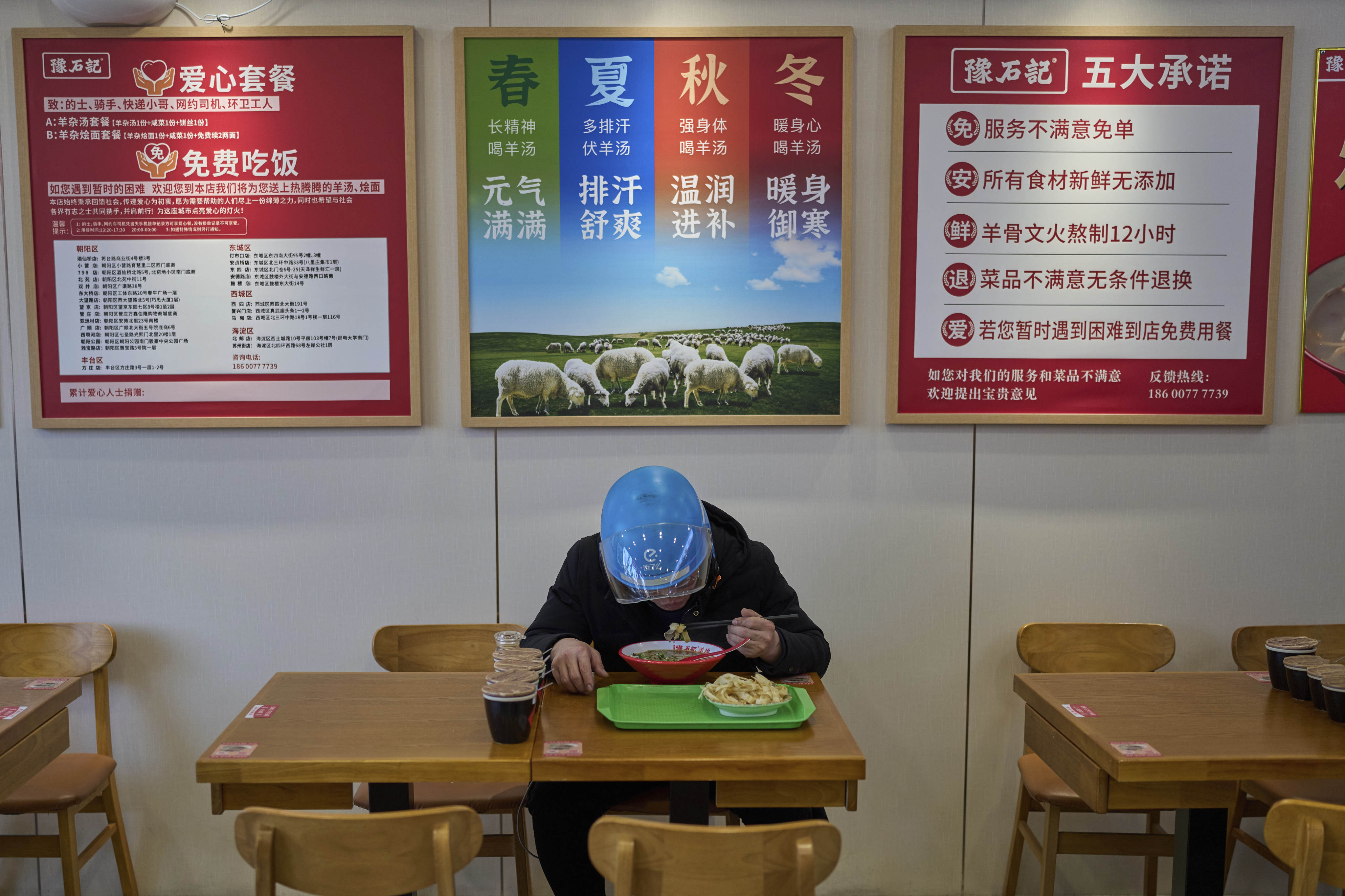 An Ele.me food delivery rider eats at a restaurant in Beijing. Photo: AP Photo