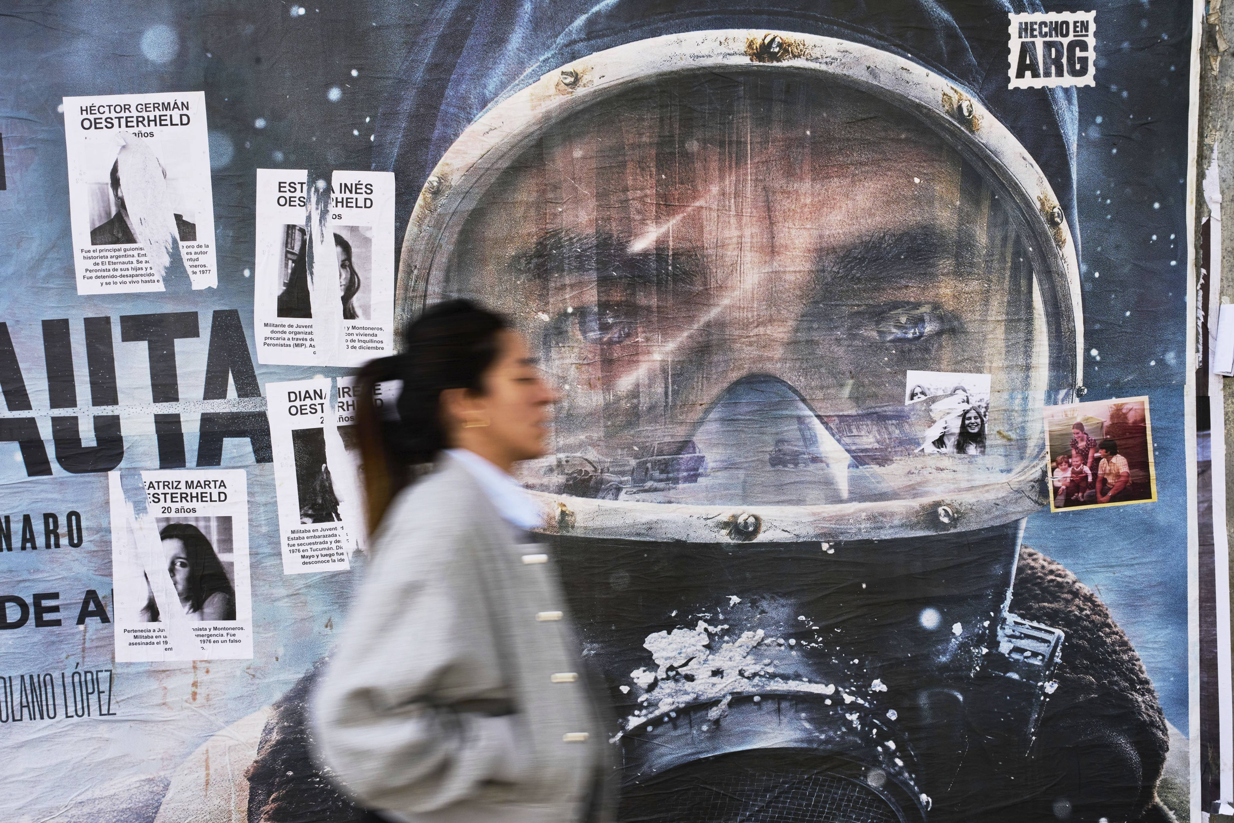 An advertisement for Netflix’s new series The Eternaut is partially covered by posters of sci-fi comic author Hector Oesterheld and his daughters - who were forcibly disappeared  in 1977 during Argentina’s military dictatorship - in Buenos Aires, Argentina, on May 6, 2025. Photo: AP