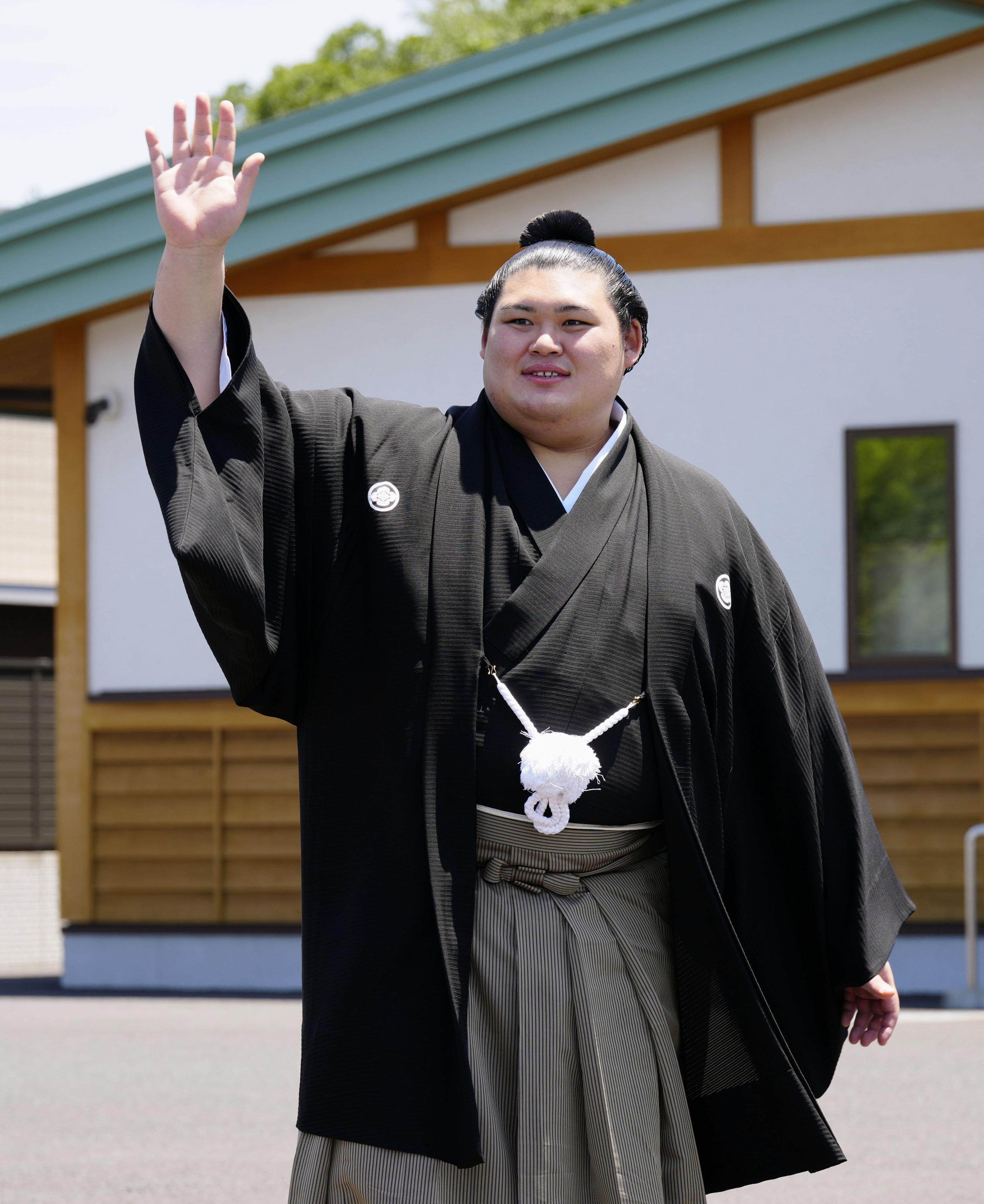 Onosato waves to fans at his stable in Ami in the Japan prefecture of Ibaraki on Wednesday after his promotion to the sport’s highest rank of yokozuna, or grand champion. Photo: Kyodo