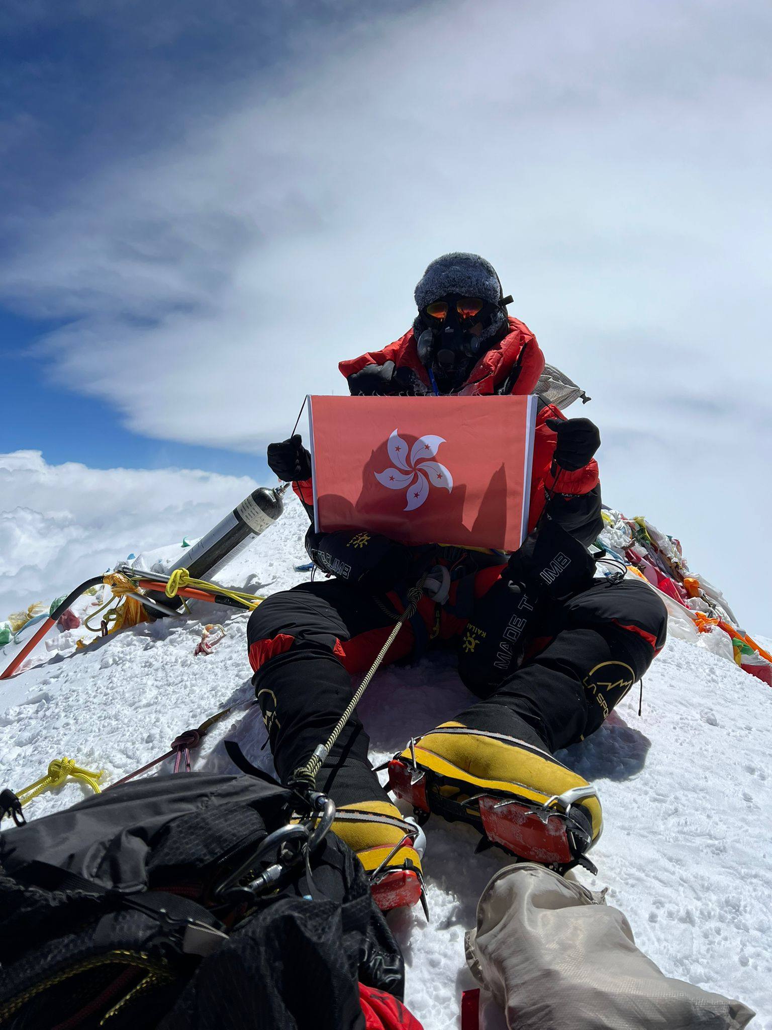 Raj Gurung poses at the summit of Mount Everest with a Hong Kong flag. Photo: Dreamers Destination Treks & Expedition
