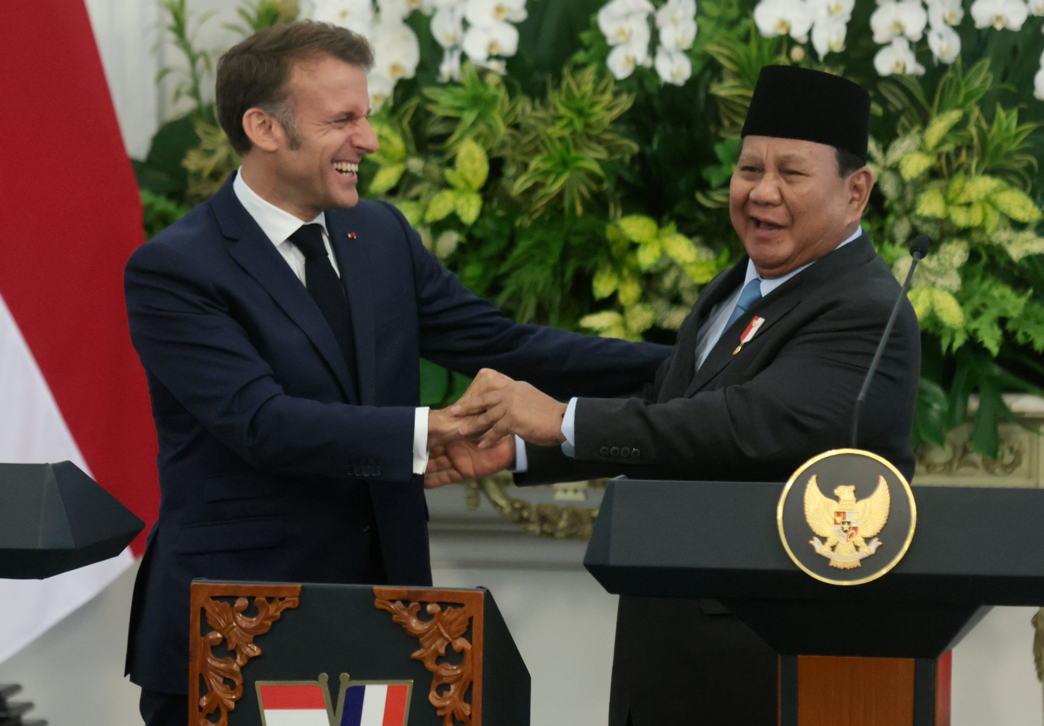France’s President Emmanuel Macron (left) laughs with Indonesian President Prabowo Subianto  at a joint press conference in Jakarta, Indonesia on Wednesday. Photo: EPA-EFE