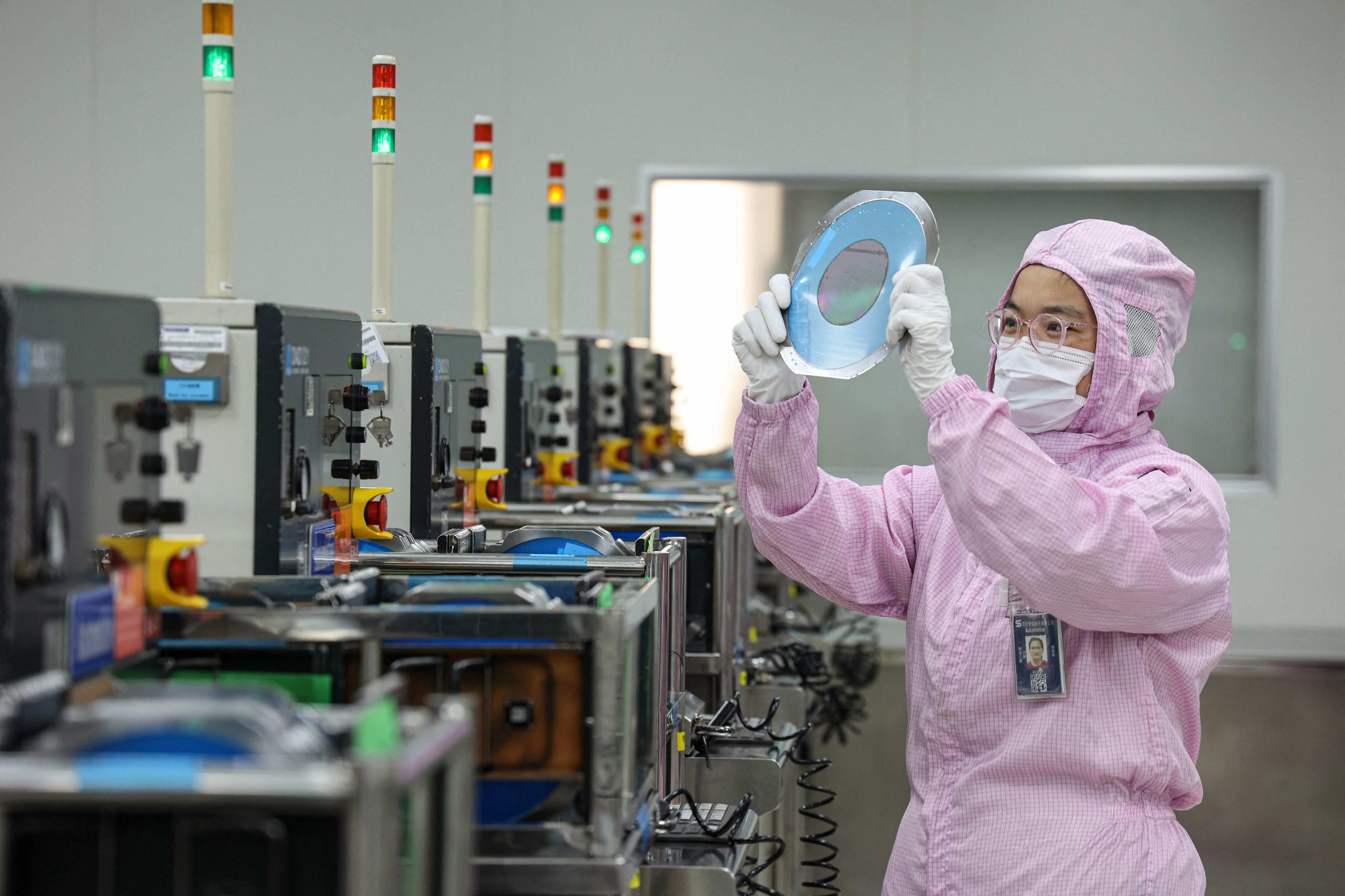 A worker handles materials during the semiconductor-production process in China’s Shandong province. Photo: AFP