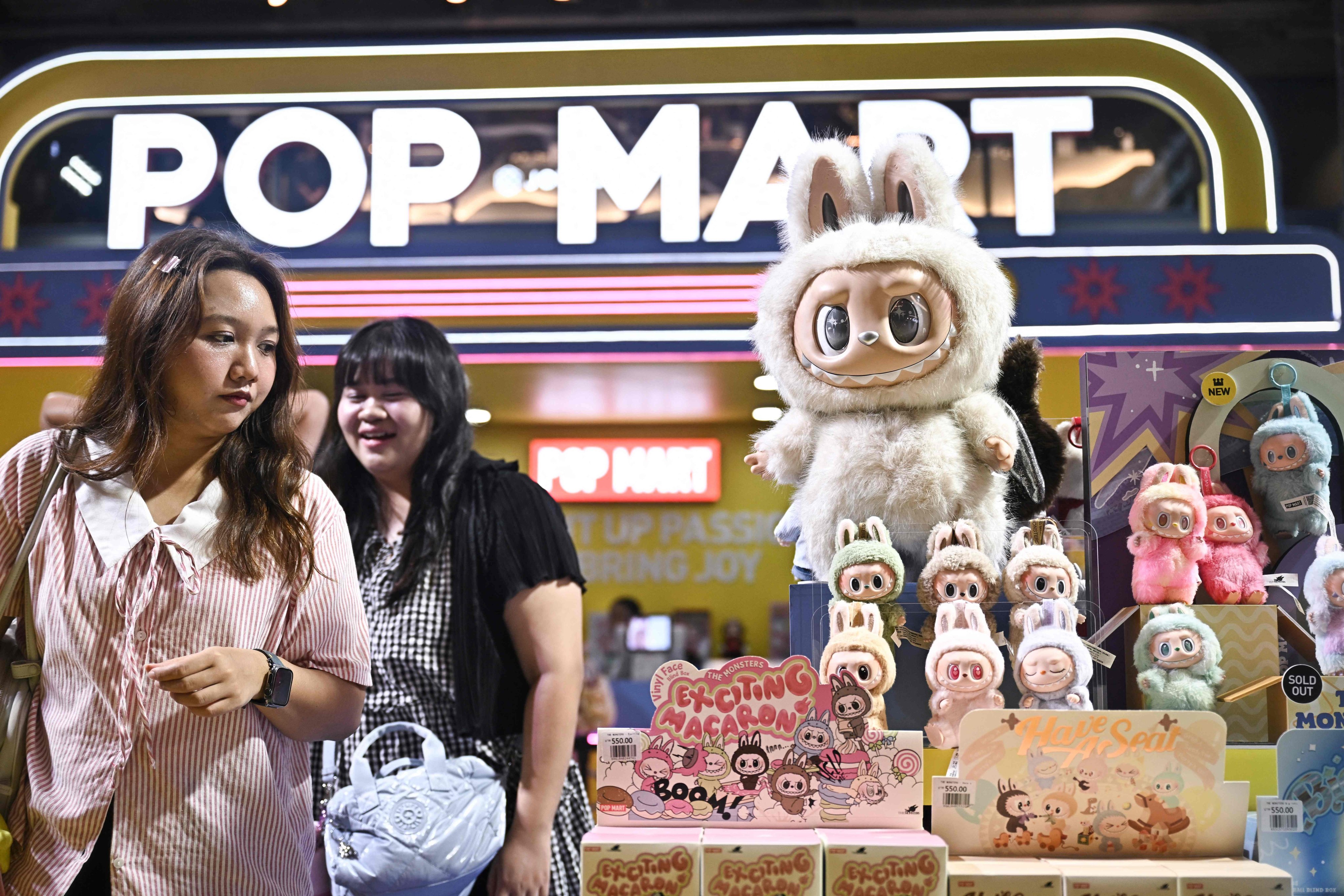 People look at collectable designer art toy Labubu at a Pop Mart pop-up store in Siam Center shopping mall in Bangkok on May 6, 2025. Photo: AFP