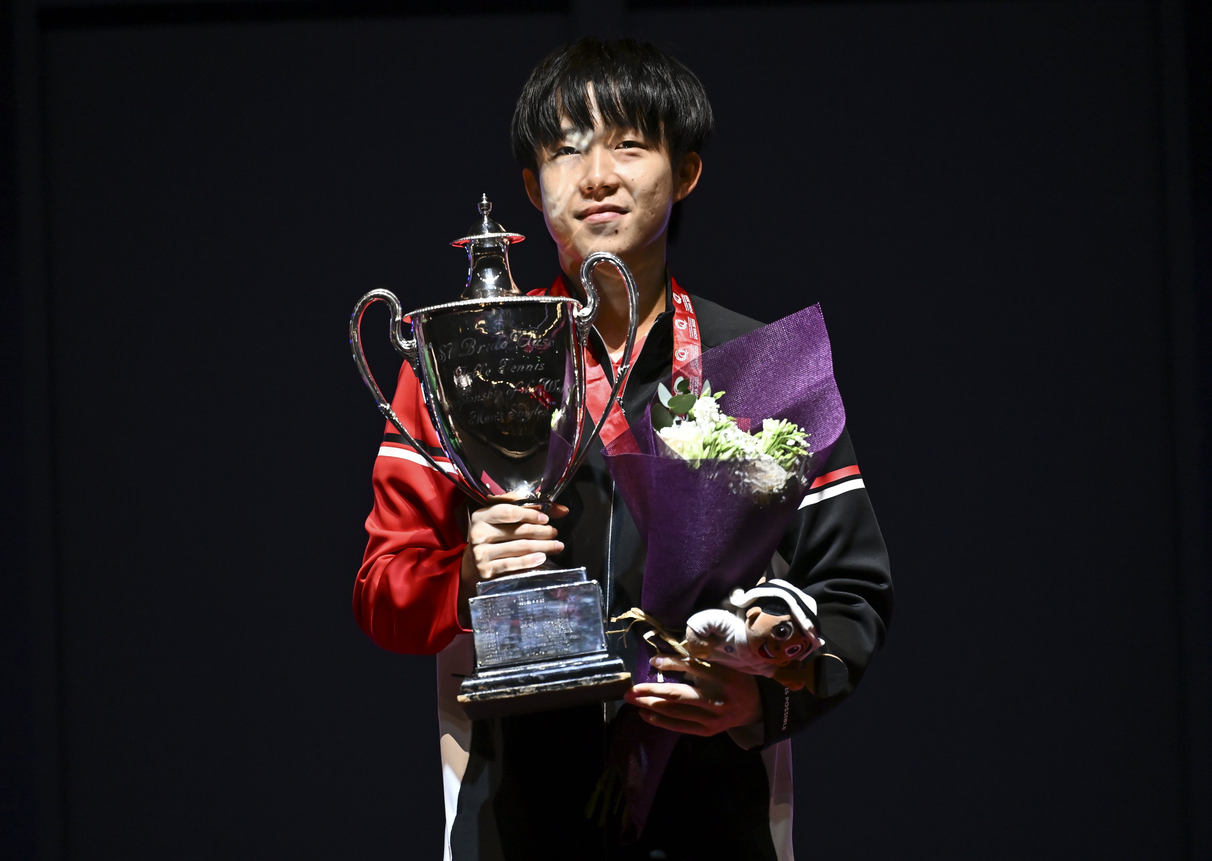 China’s Wang Chuqin poses with the trophy during the medal ceremony after securing victory in the men’s singles event at the World Table Tennis Championships. Photo: EPA