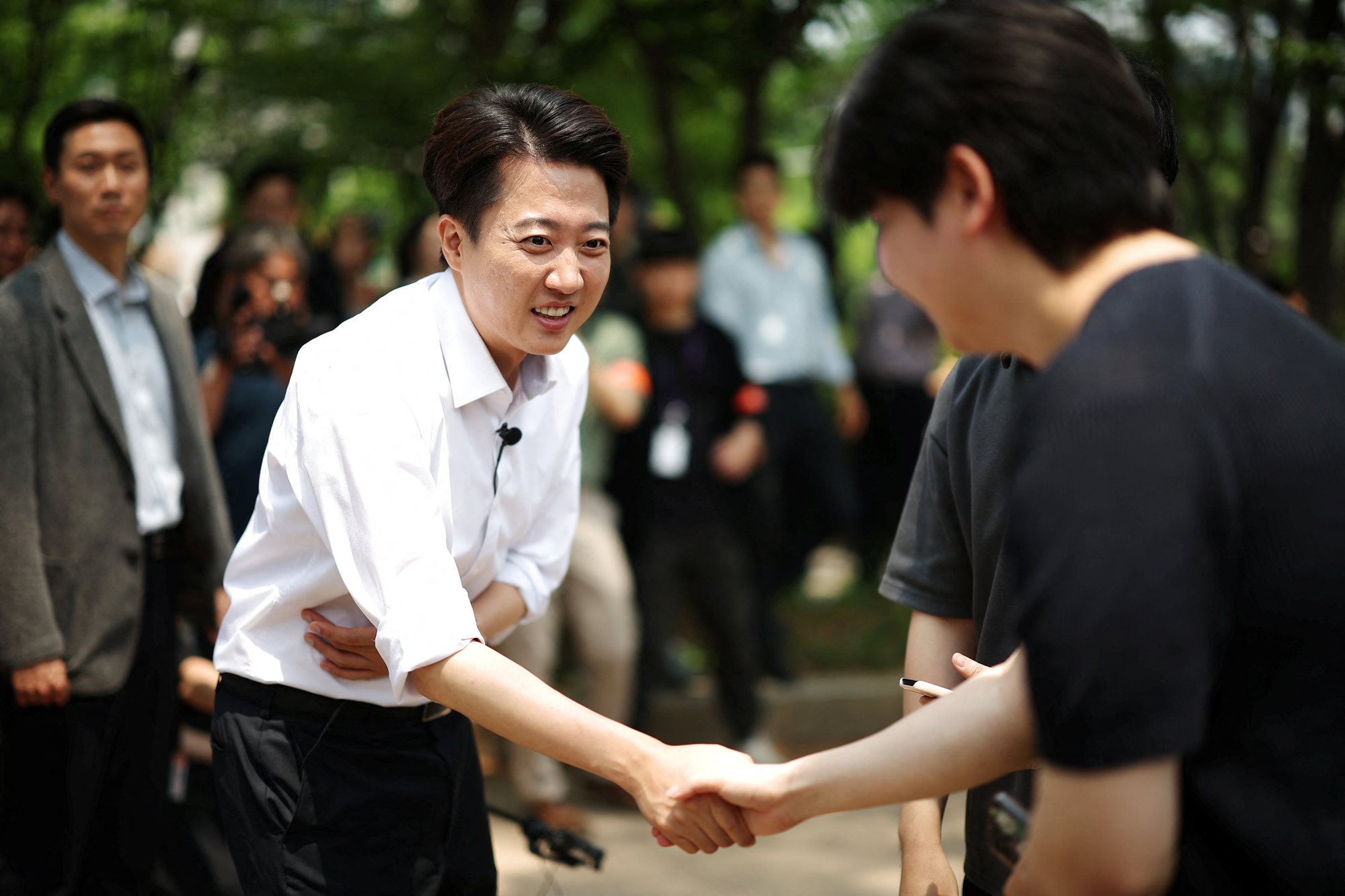 Lee Jun-seok, the presidential candidate for South Korea’s Reform Party, shakes hands with his supporter during an election campaign rally at a park in Seoul on Wednesday. Photo: Reuters Lee Jun-seok, the presidential candidate for South Korea’s Reform Party, shakes hands with his supporter during an election campaign rally at a park in Seoul on Wednesday. Photo: Reuters