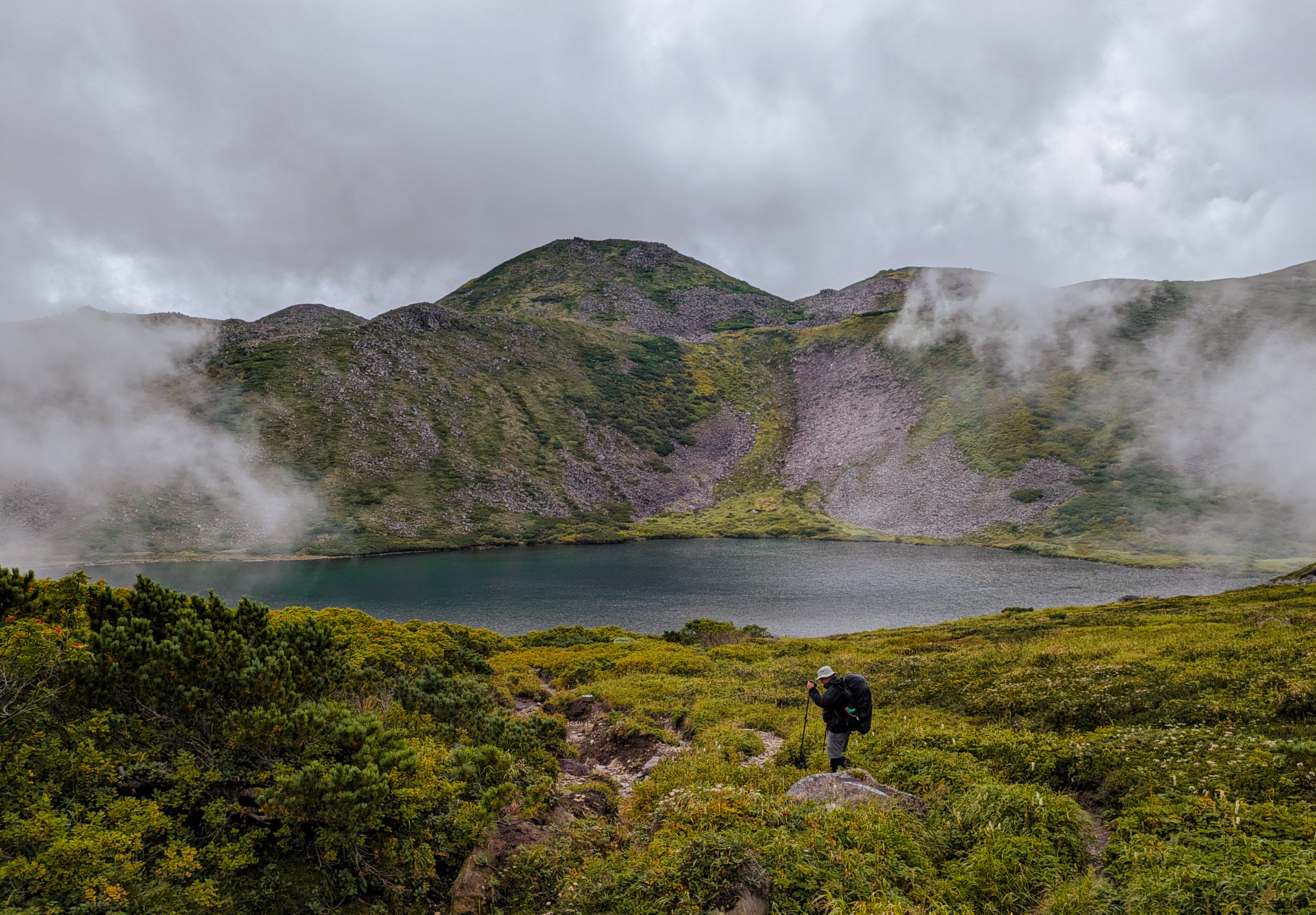 The writer Cameron Dueck trekking past a lake in Daisetsuzan National Park. Photo: Fiona Ching
