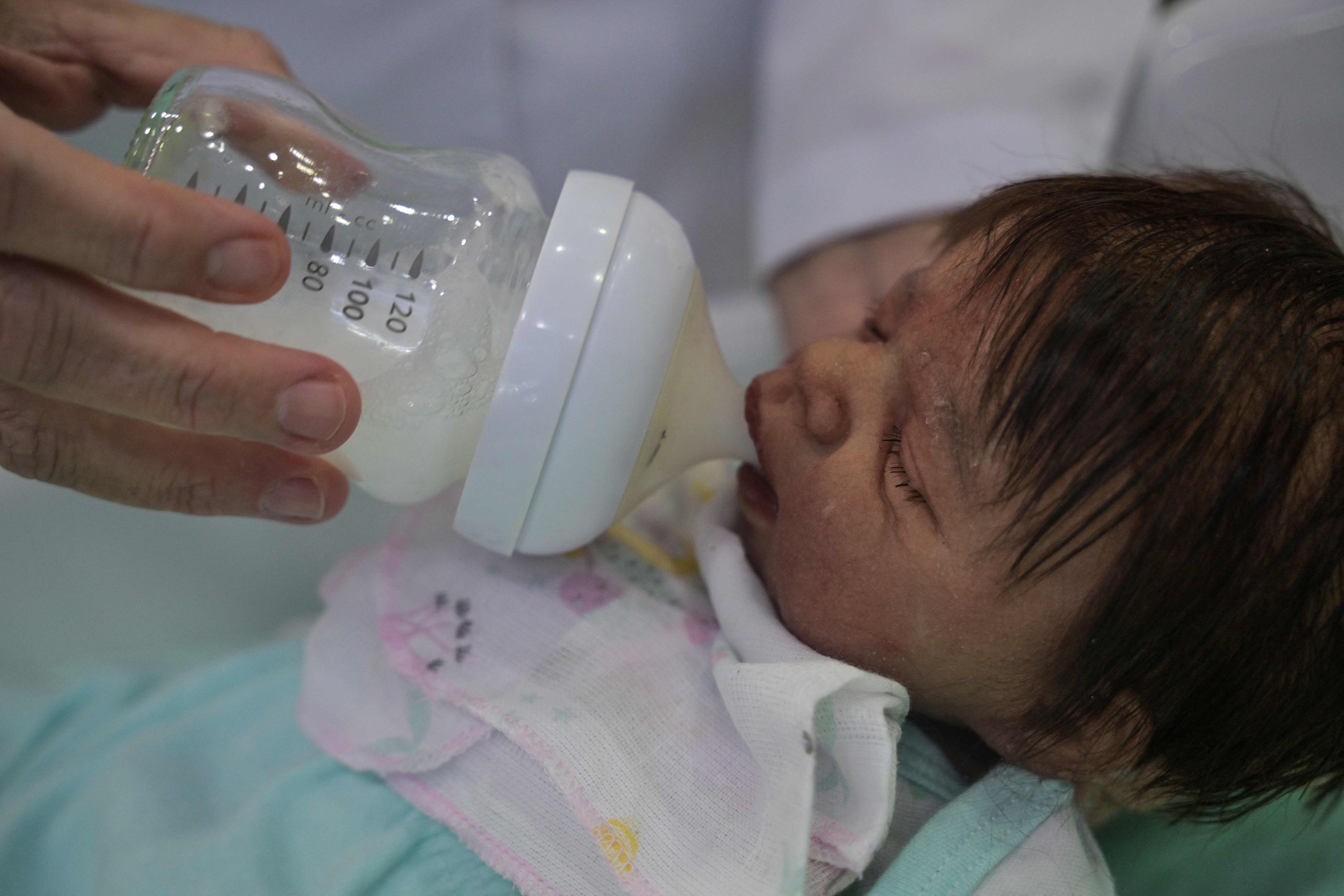 Brazilian shopkeeper Alana Generoso bottle-feeds a reborn baby doll at her store Alana Babys Maternity in Campinas, Sao Paulo state, Brazil. Photo: AFP
