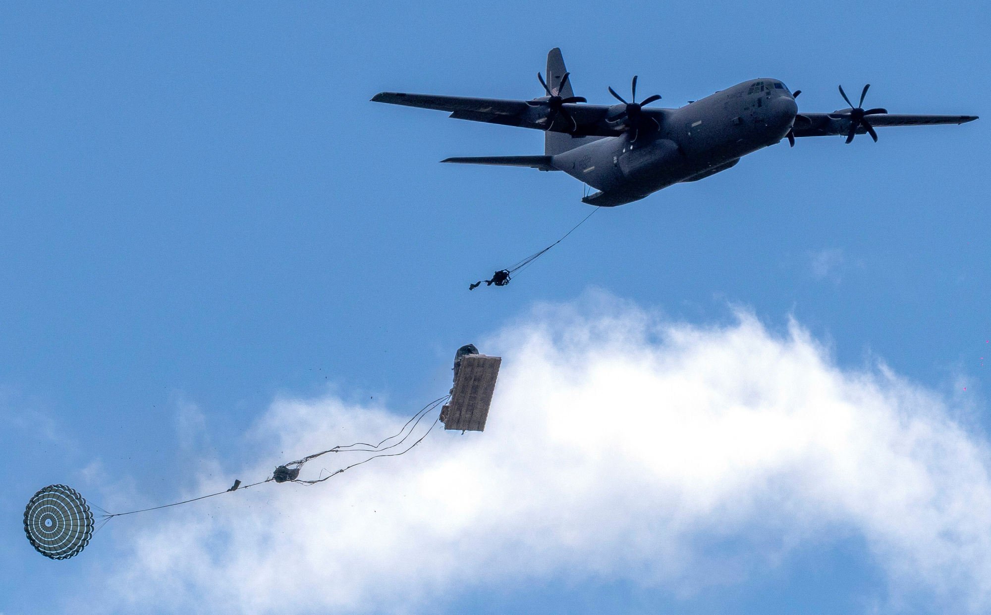 US Army aircraft Lockheed Martin Super Hercules drops equipment during military exercises in Lithuania on May 16. BlackRock holds shares in the company, which supplies arms to Israel. Photo: AP