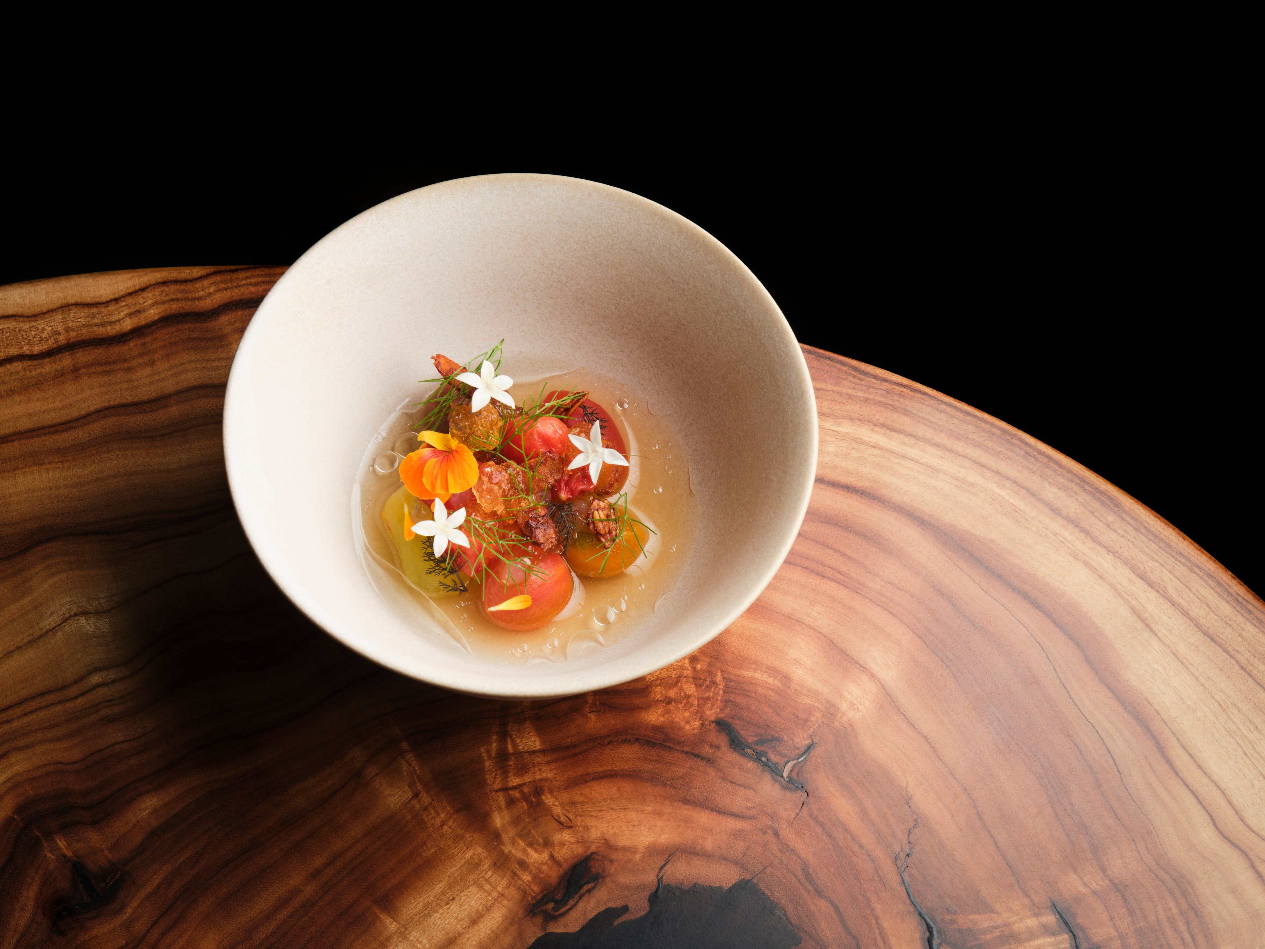 Farmhouse tomatoes in perilla and coal with fermented pistachio, at Roganic in Hong Kong. Photo: Handout
