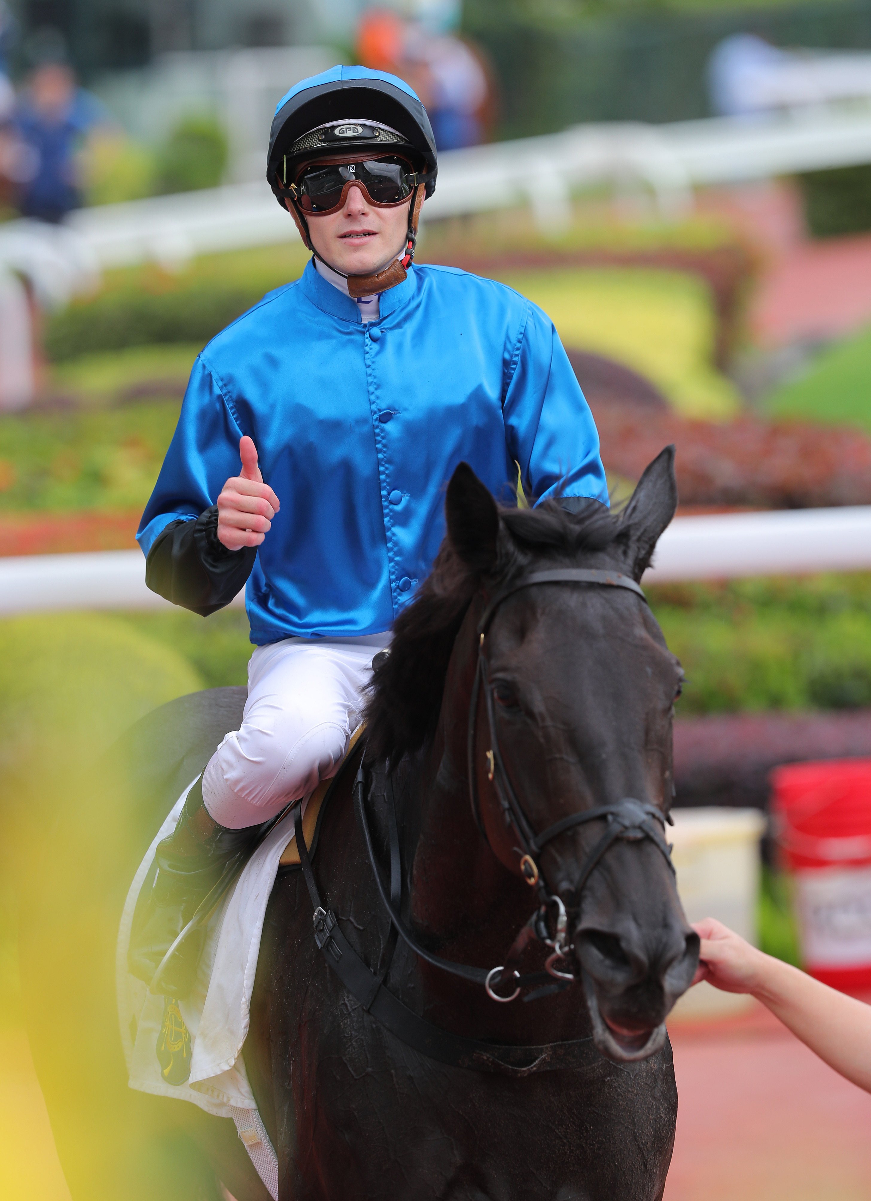 Luke Ferraris gives a thumbs up after winning aboard Dazzling Fit. Photo: Kenneth Chan