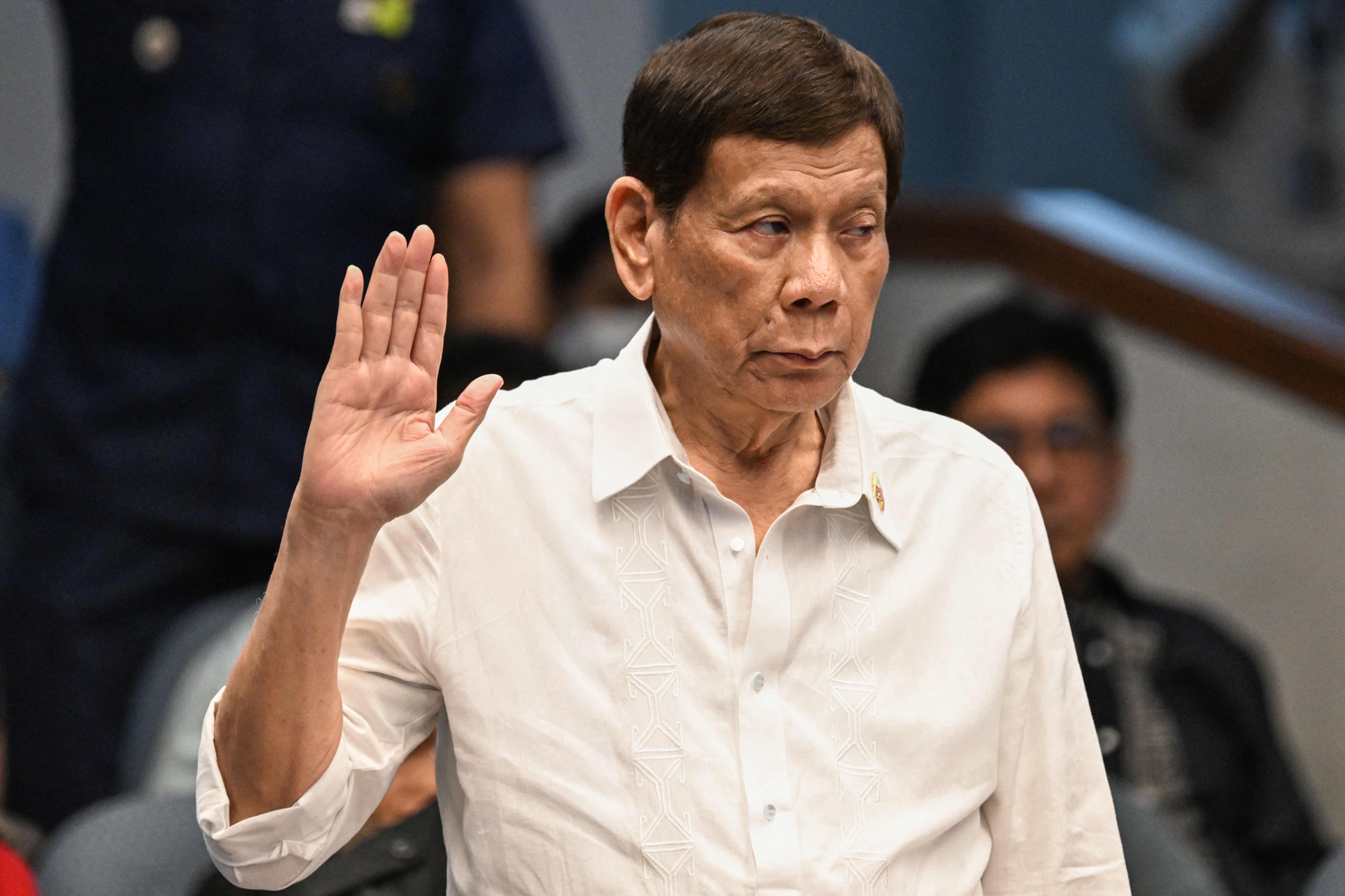 Former Philippine president Rodrigo Duterte takes an oath as he attends a Senate investigation into his drug war last year. Photo: AFP