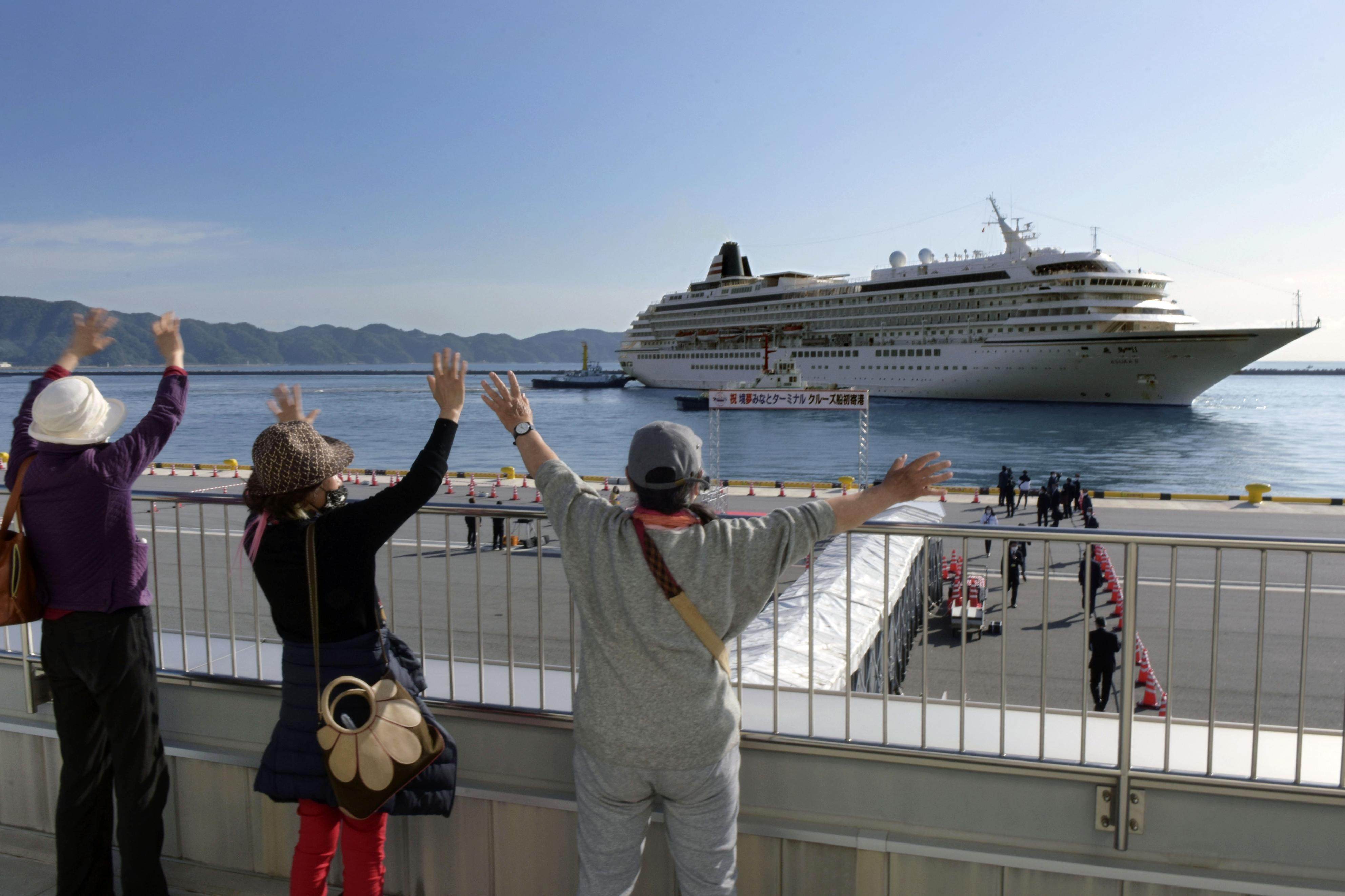 People welcome the Asuka II cruise ship at a port in western Japan’s Sakaiminato in 2021. Photo: Kyodo via Getty Images