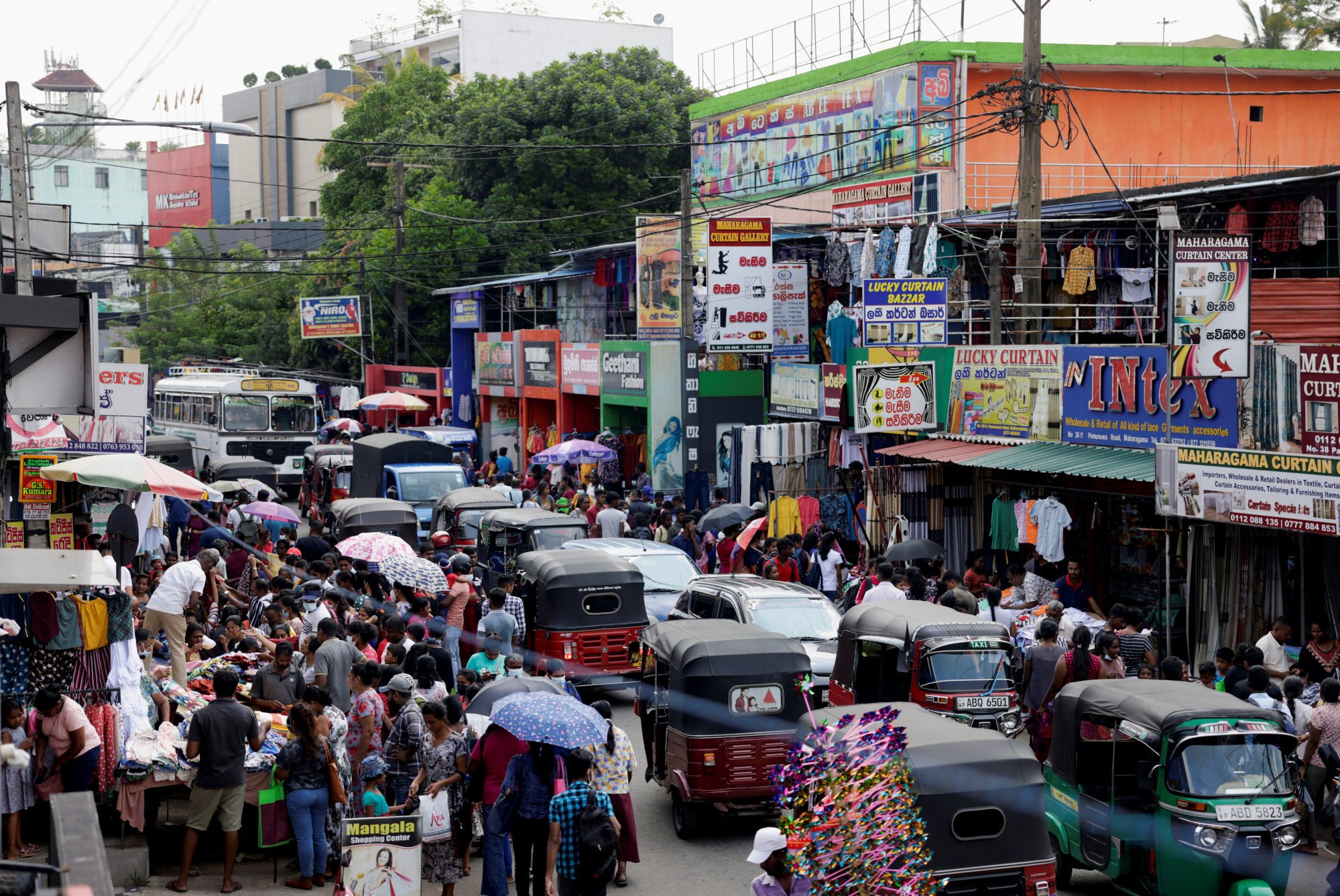 People gather around ready-made clothing stalls to purchase ahead of the Sinhala and Tamil New Year festival, in Colombo, Sri Lanka in April 2023. Photo: Reuters People gather around ready-made clothing stalls to purchase ahead of the Sinhala and Tamil New Year festival, in Colombo, Sri Lanka in April 2023. Photo: Reuters