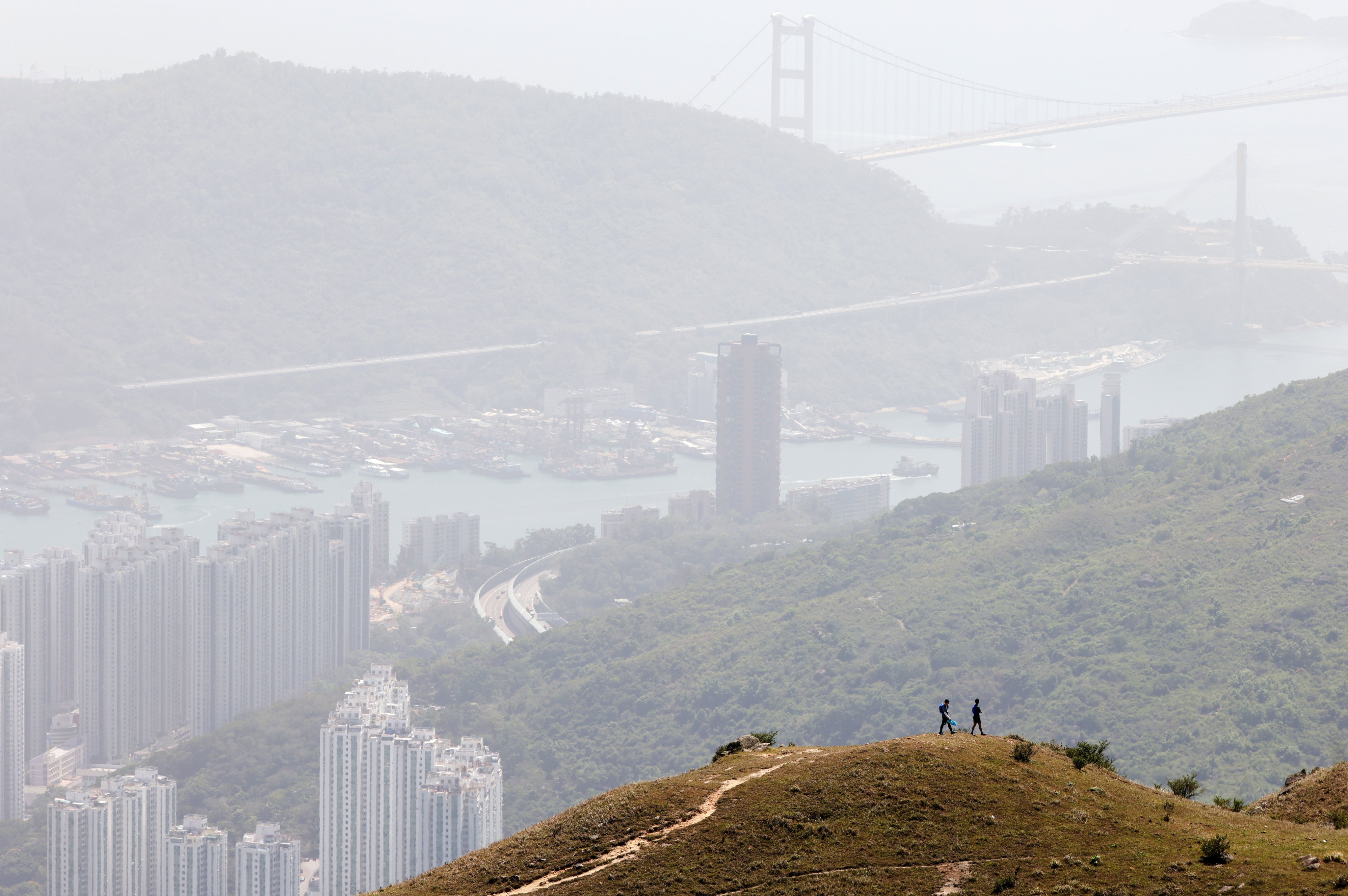 Hikers on Tai Mo Shan get a smoggy view of Tsuen Wan and Tsing Yi. Photo: Eugene Lee