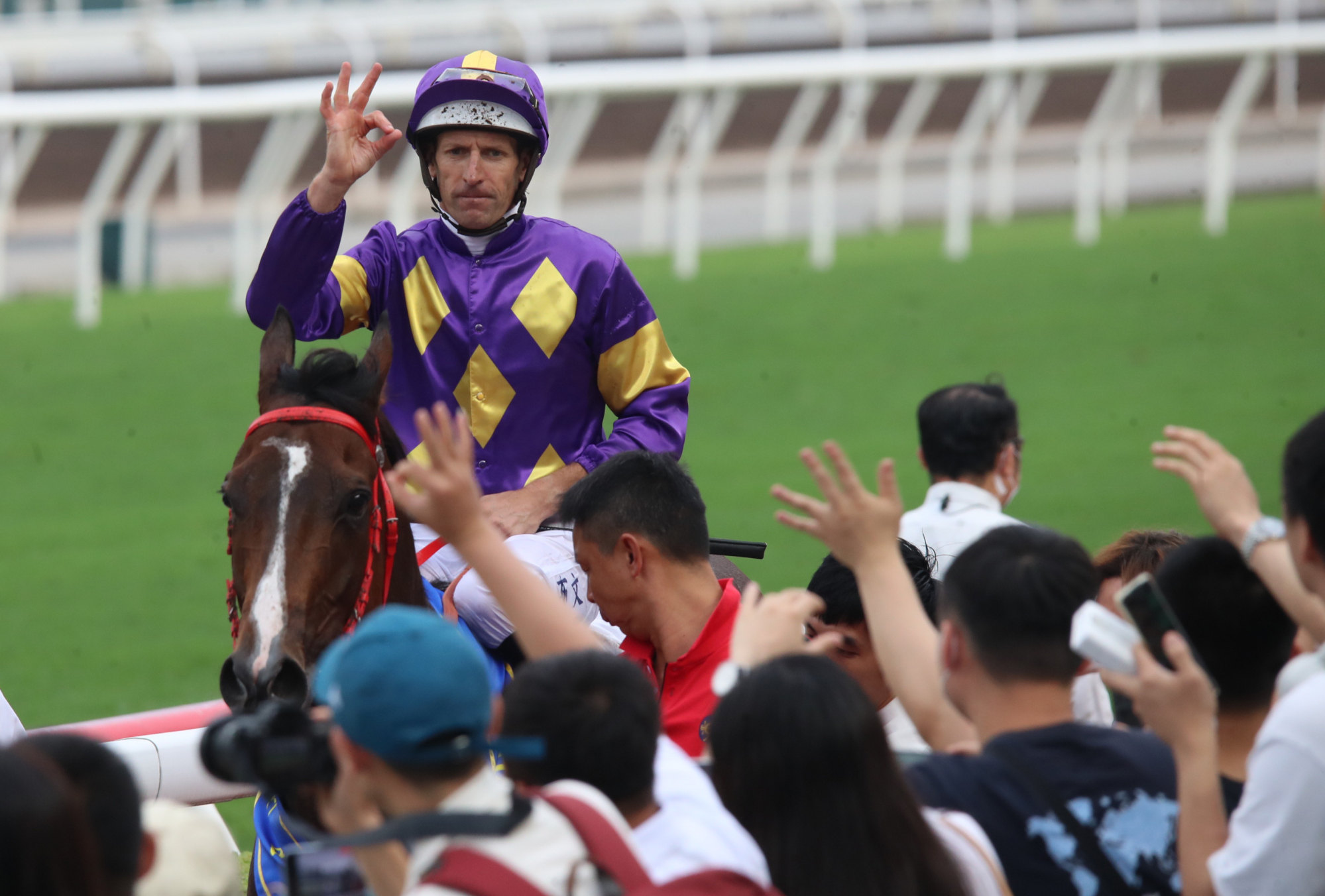 Hugh Bowman salutes the Sha Tin crowd after booting home Helios Express.