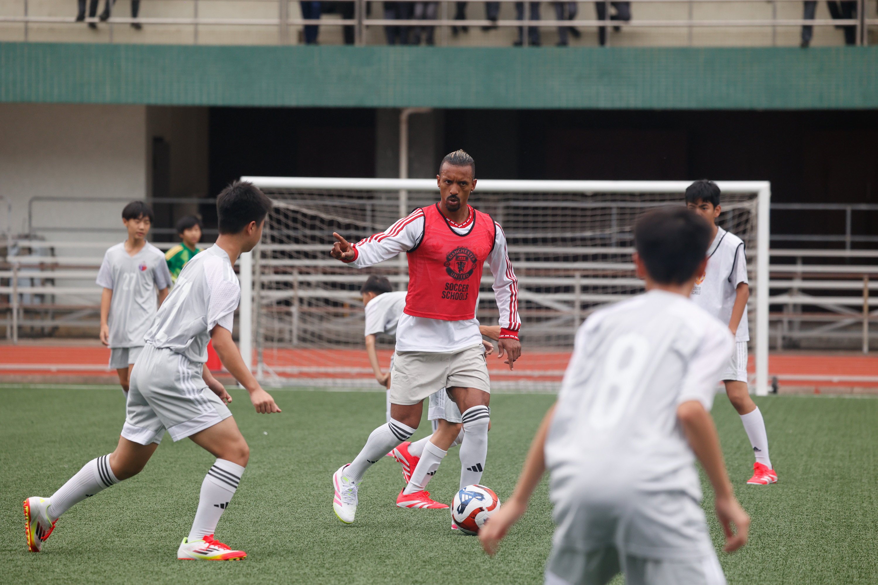Former Manchester United player Nani (right) runs a training session for pupils at La Salle College in Hong Kong. Photo: Handout