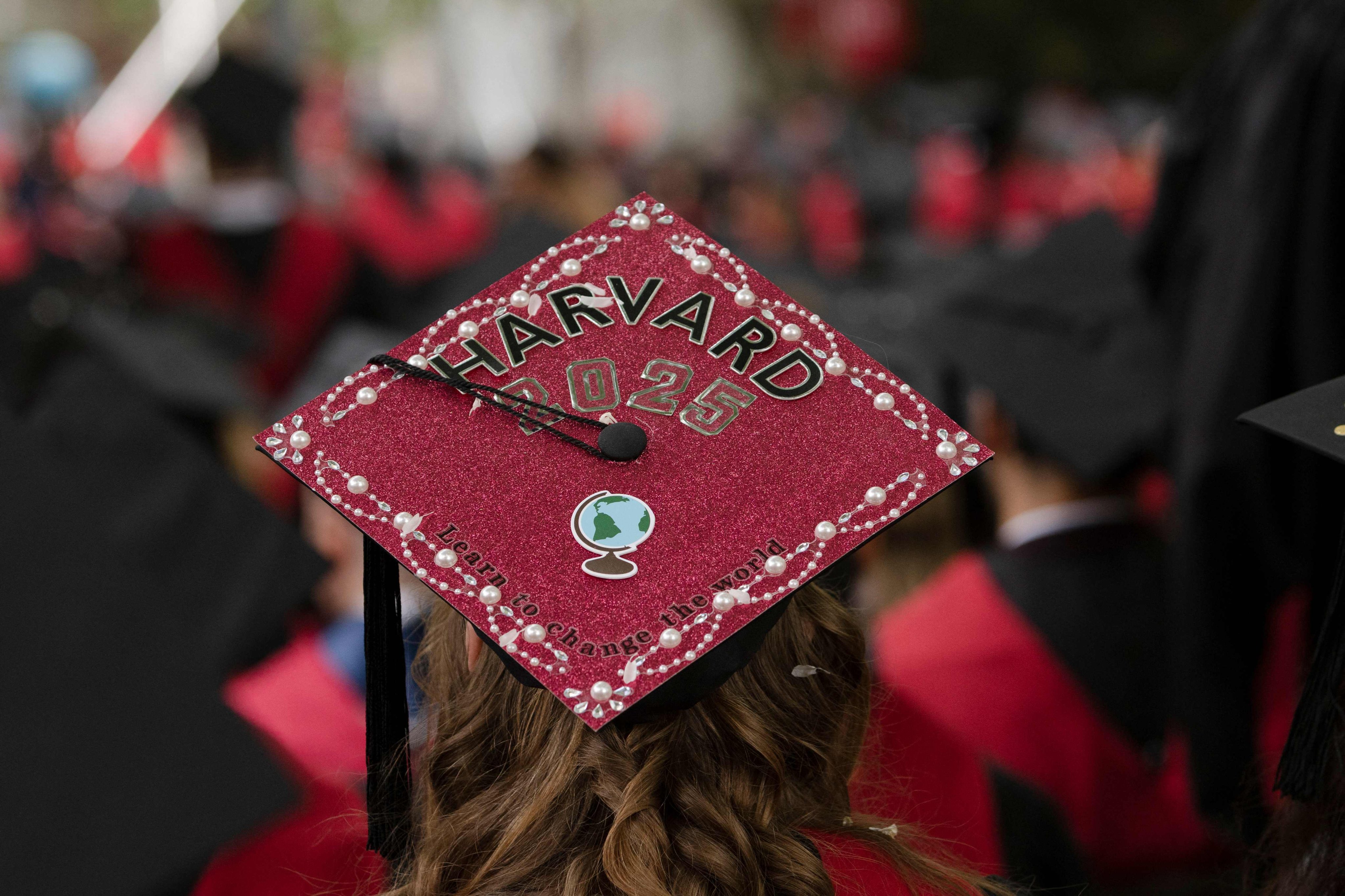 A graduate’s cap reads “Learn to Change the World” during Harvard’s commencement ceremony in Cambridge, Massachusetts, on Thursday. Photo: AFP