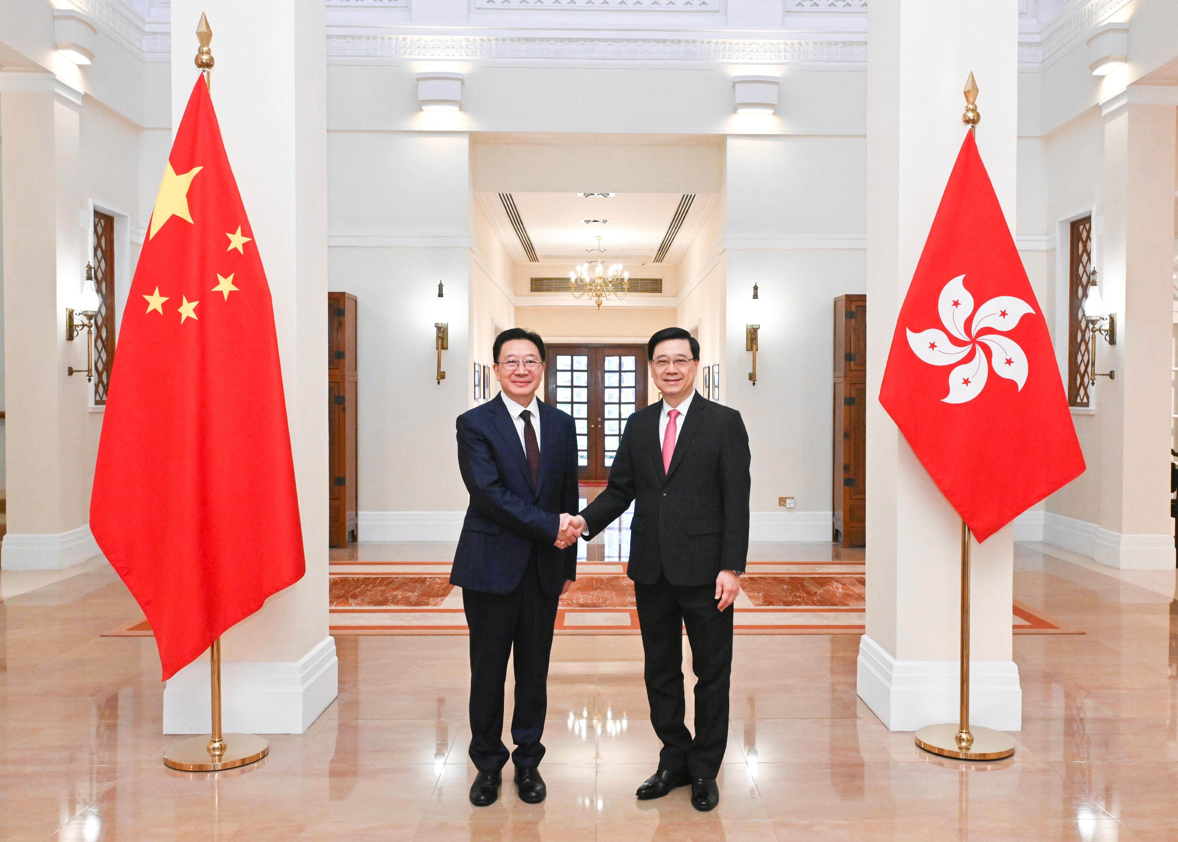 Liaison office Director Zhou Ji (left) meets Hong Kong leader John Lee at Government House on Saturday. Photo: ISD