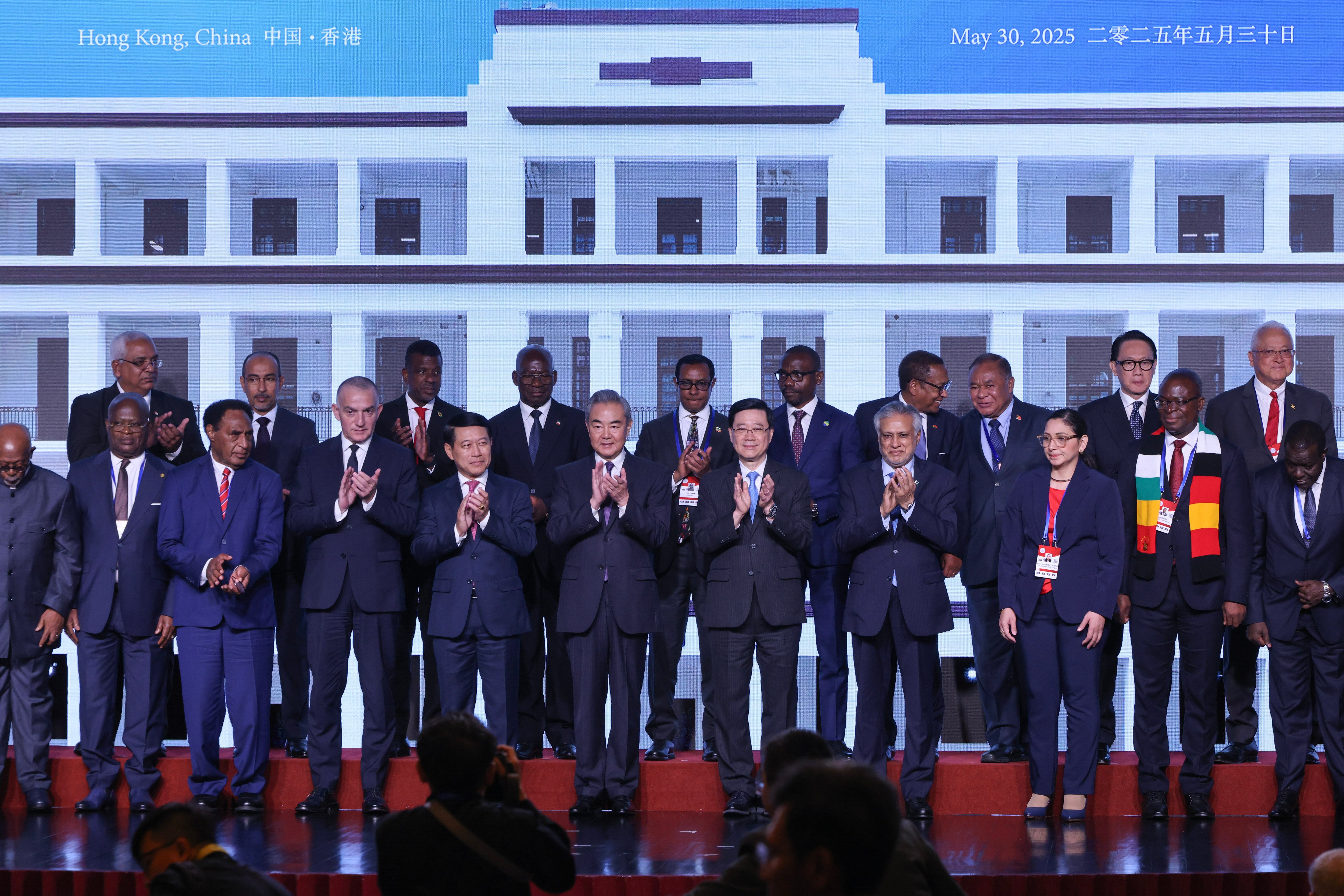 Chinese Foreign Minister Wang Yi (sixth from left) and Chief Executive John Lee Ka-chiu (seventh from left) attend the signing ceremony of the Convention on the Establishment of The International Organization for Mediation on Friday. Photo: Nora Tam