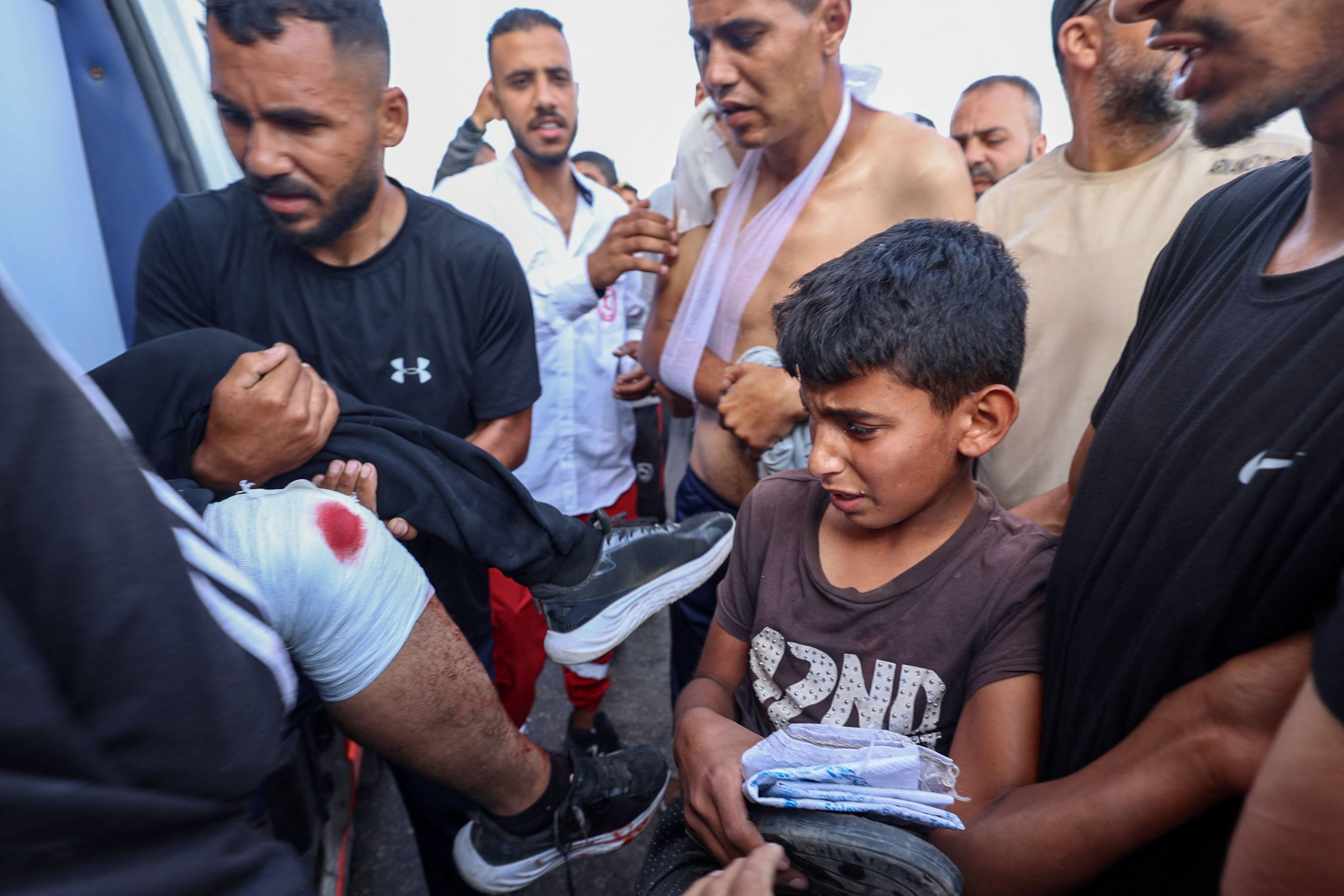 Palestinian rescuers evacuate injured people in an ambulance after an Israeli drone reportedly opened fire on civilian gatherings near an aid distribution point on Sunday. Photo: AFP