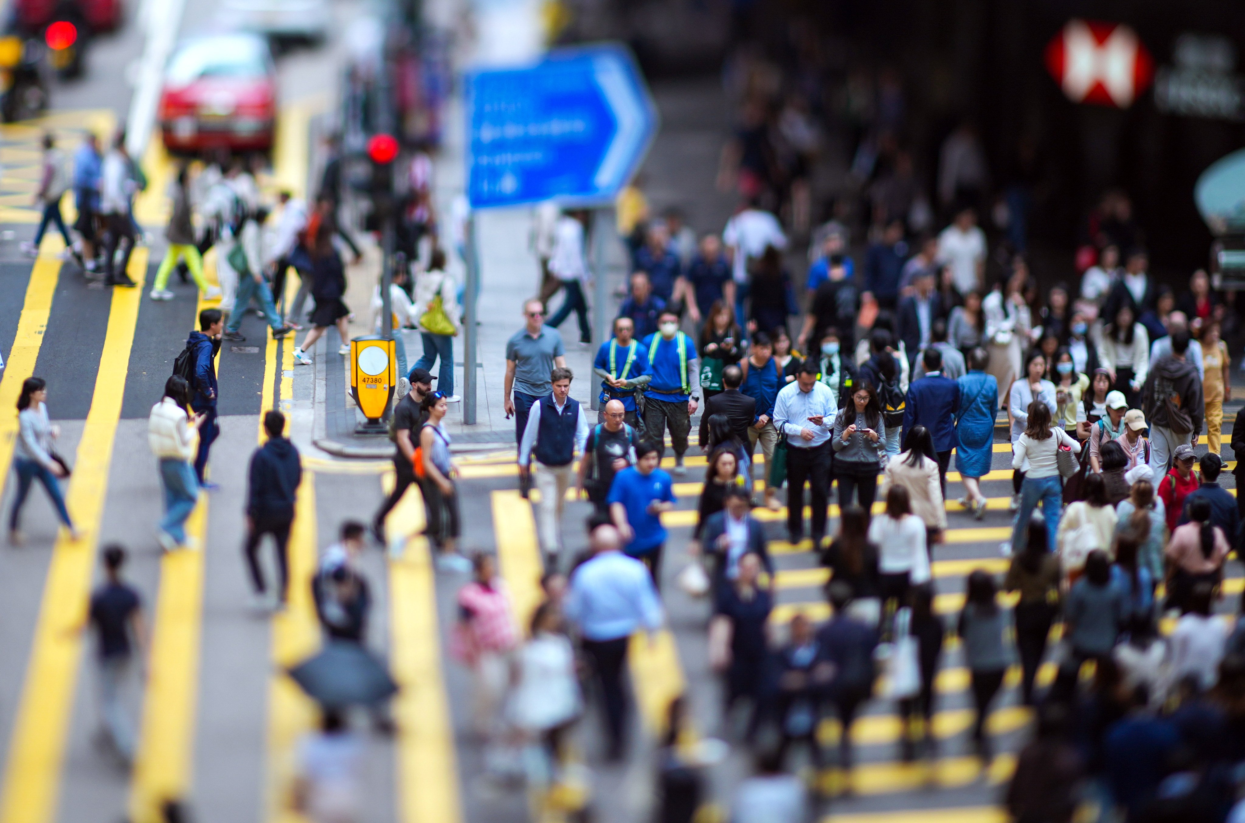 Hongkongers at a pedestrian crossing in Central. The eMPF will ultimately allow 12 service providers, 367,000 employers and 4.75 million members to manage fund assets worth HK$1.326 trillion. Photo: Eugene Lee