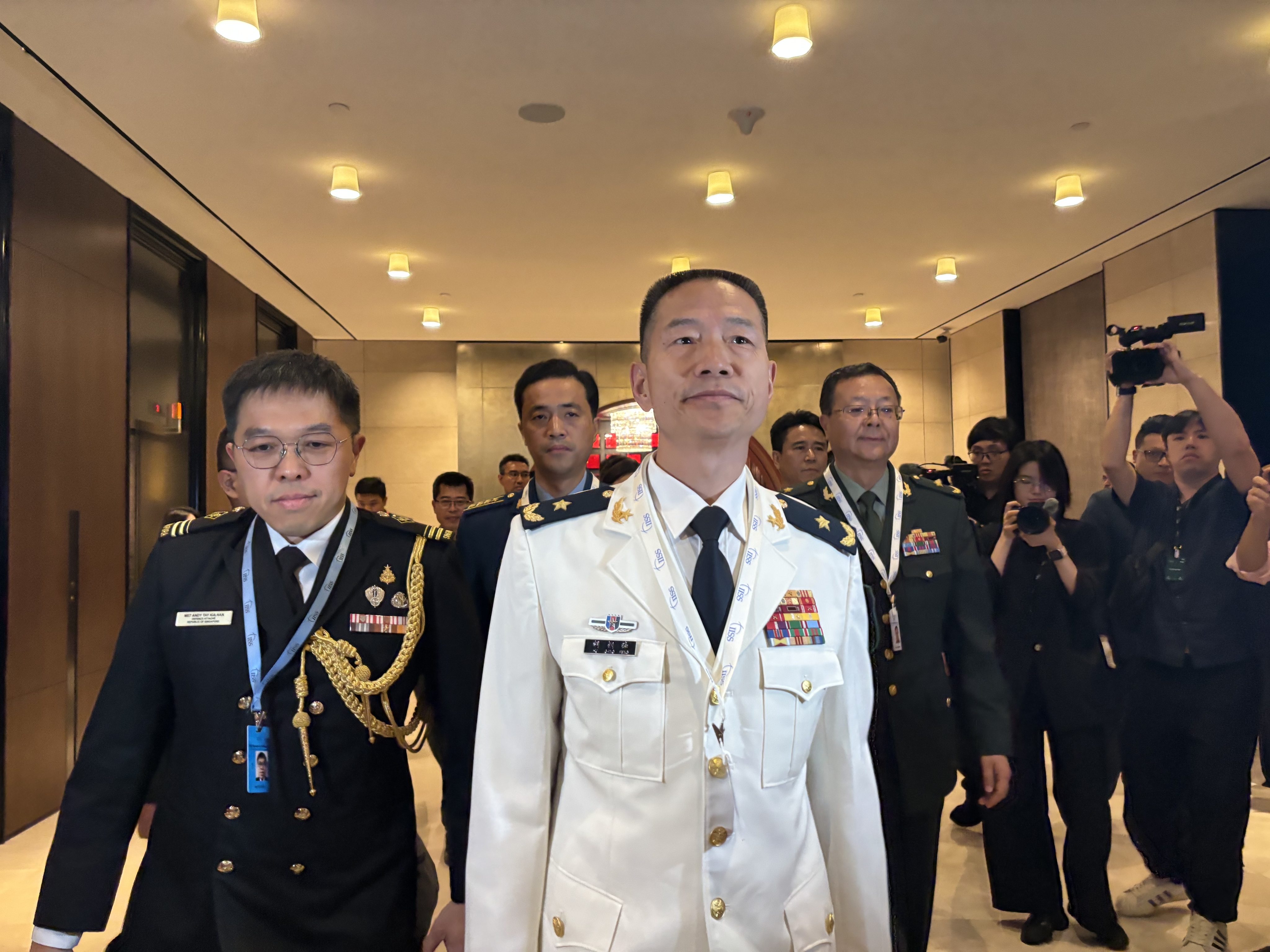 Hu Gangfeng (centre), a PLA major general and leader of China’s delegation to the Shangri-La Dialogue in Singapore, arrives for the forum’s opening ceremony on Friday. Photo: Hayley Wong