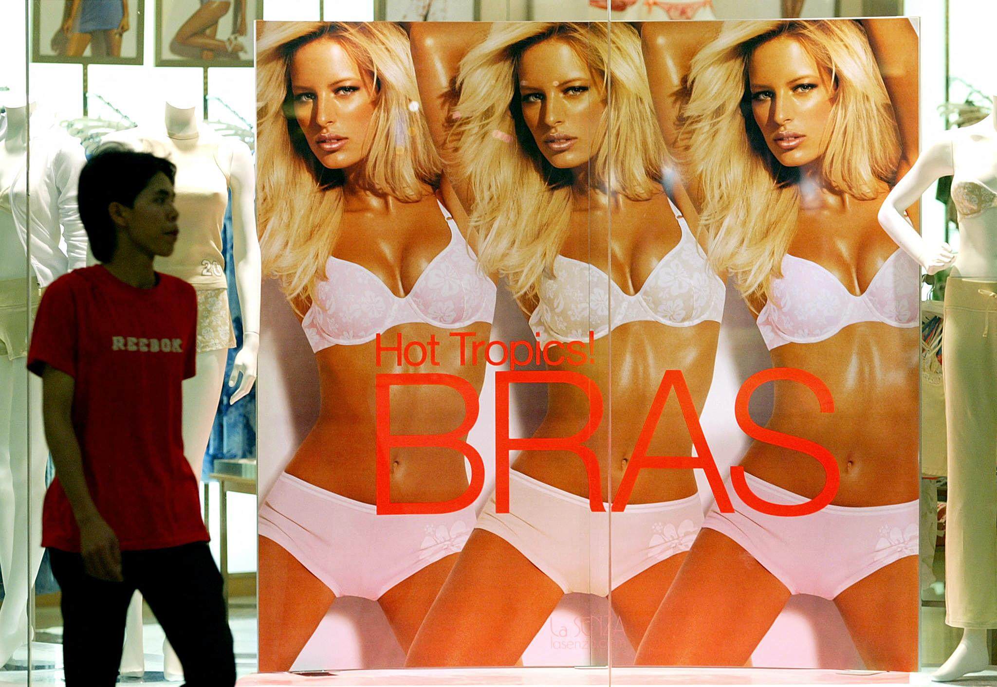 A man walks past a poster advertising women’s underwear at a shopping centre in Kuala Lumpur, Malaysia. Photo: AFP