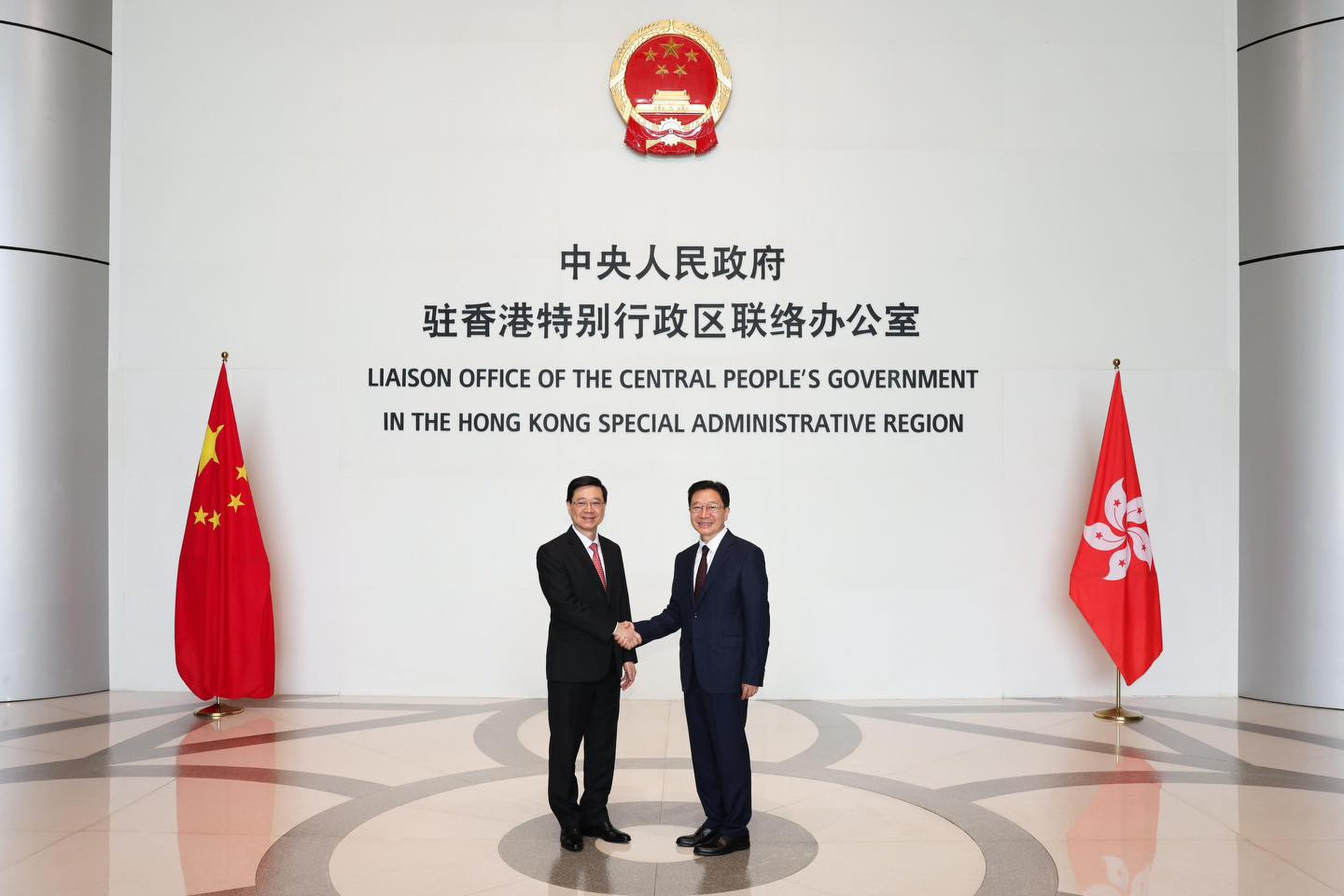 Liaison office Director Zhou Ji (left) and Chief Executive John Lee meet on Monday. Photo: Handout