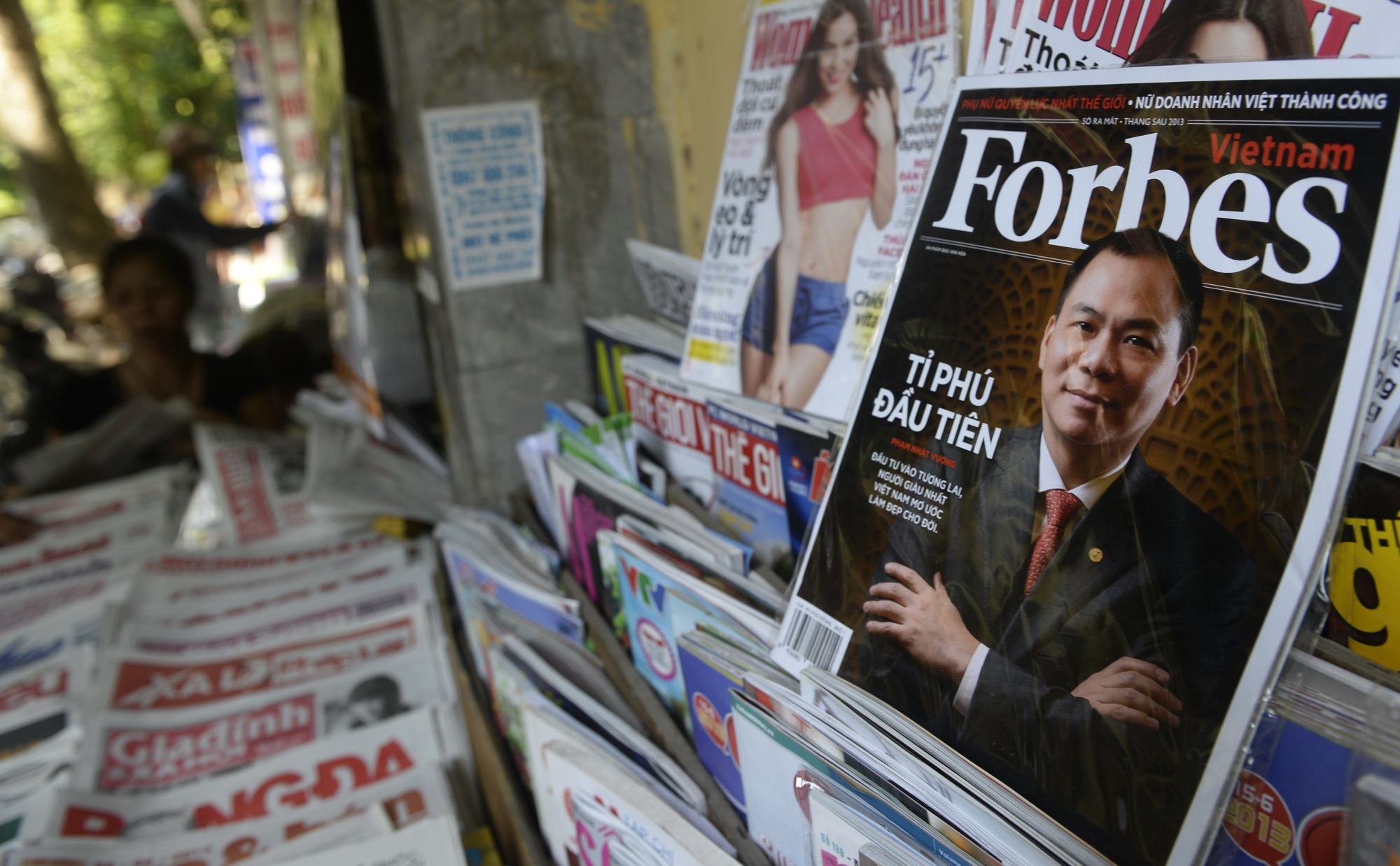 A copy of Forbes Vietnam magazine with Pham Nhat Vuong on the cover is seen for sale at a roadside newsstand in Hanoi. Photo: AFP A copy of Forbes Vietnam magazine with Pham Nhat Vuong on the cover is seen for sale at a roadside newsstand in Hanoi. Photo: AFP