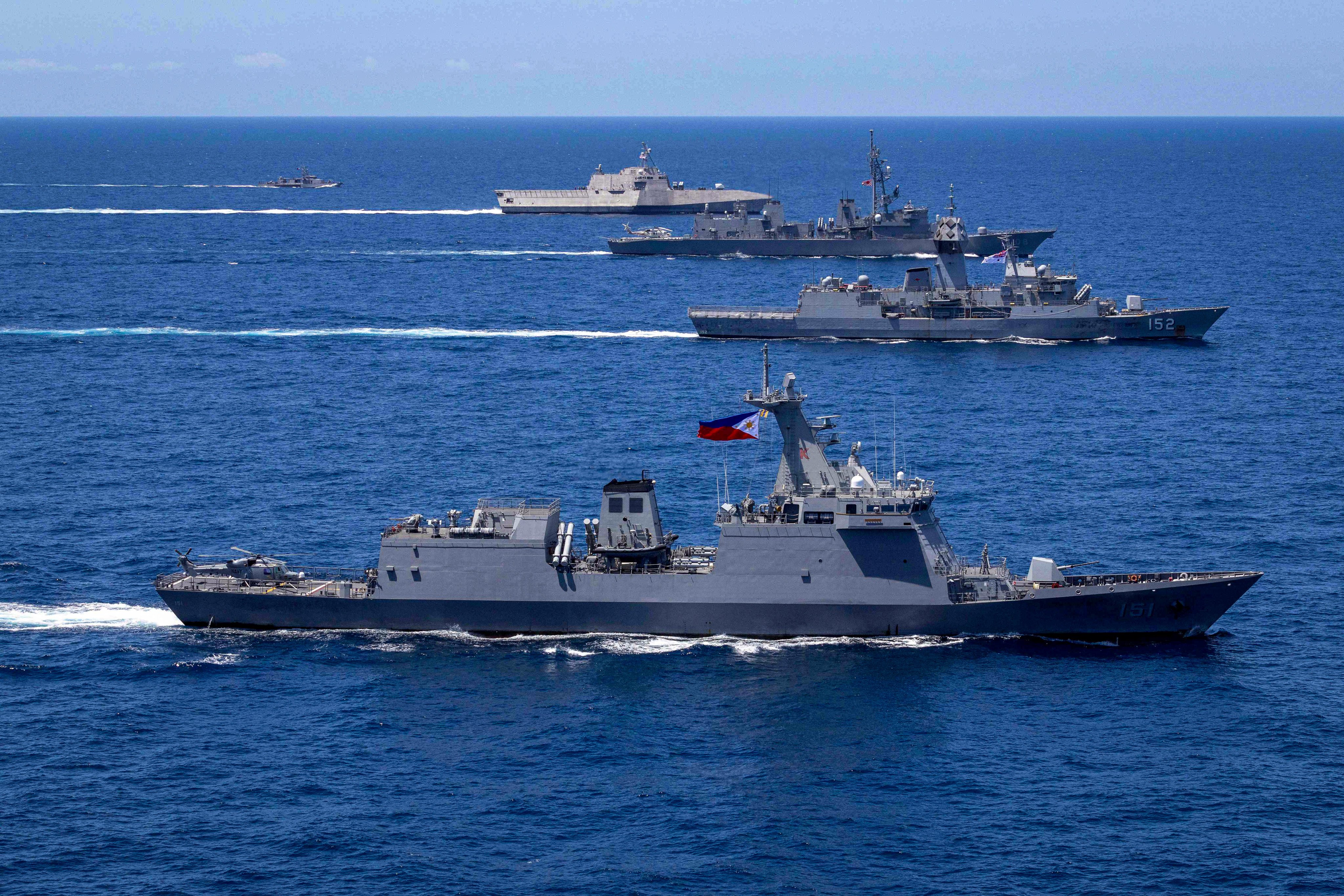 Vessels sail in formation during a multilateral maritime cooperative activity between Australia, the United States, Japan and the Philippines in April 2024. Photo: Australian Department of Defence / AFP