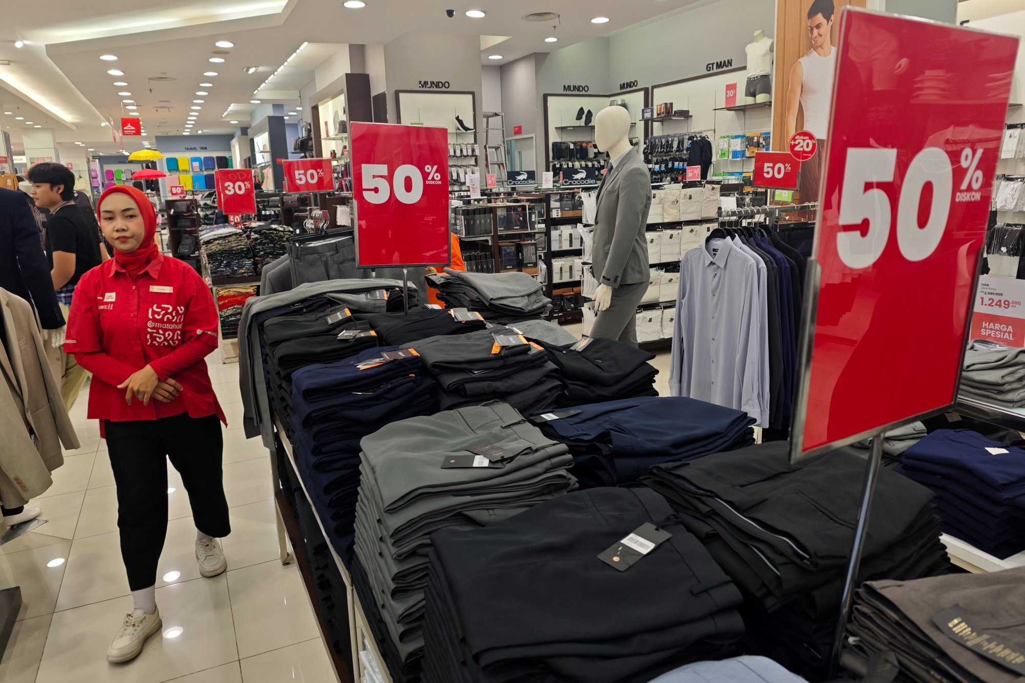 An employee stands at a clothing store inside a shopping centre in Depok, Indonesia. Health minister Budi has said men who wore larger jeans sizes “are definitely obese [and] will face Allah faster”. Photo: EPA-EFE