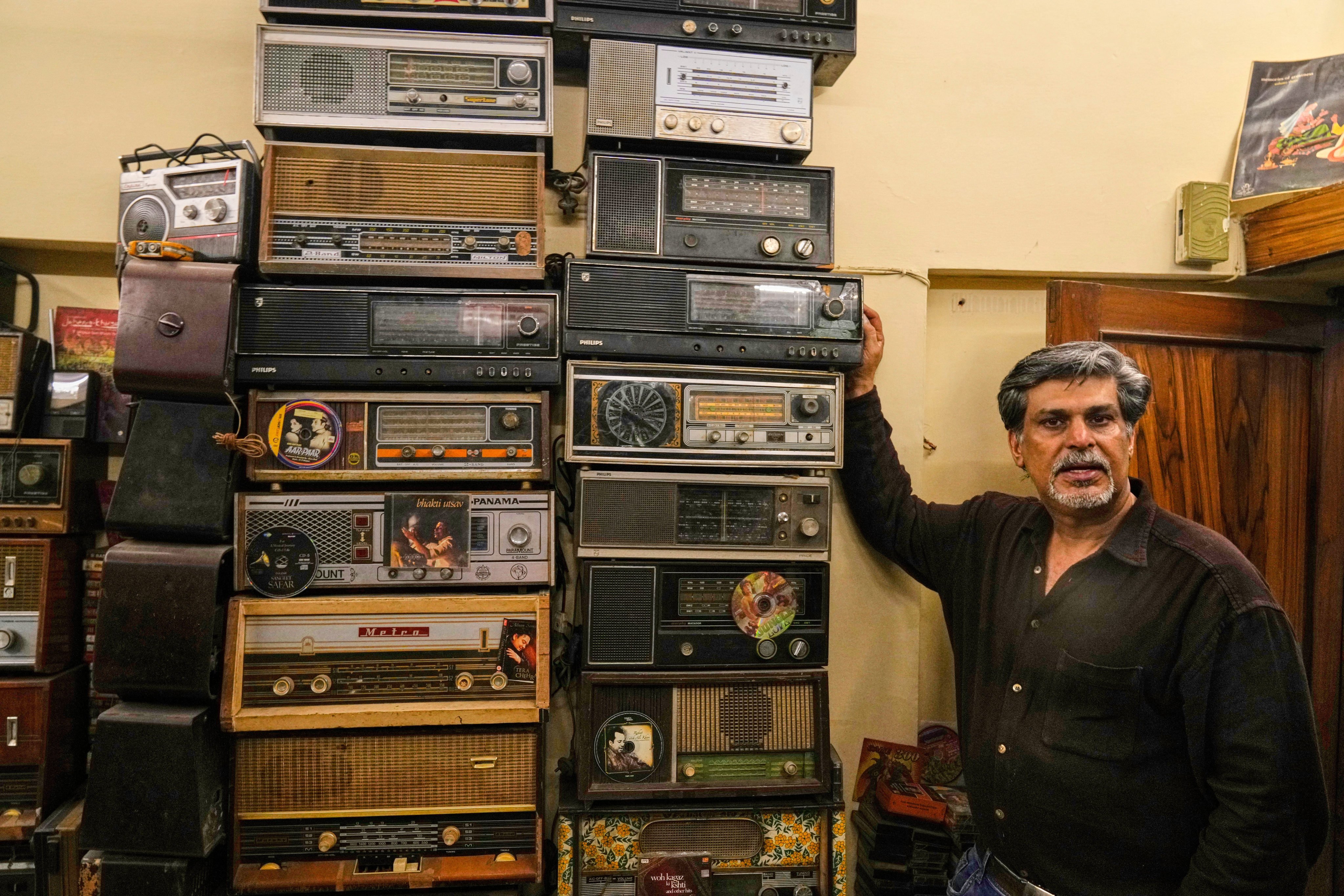 Indian collector Aditya Vij with some of his old radios. Photo: AP
