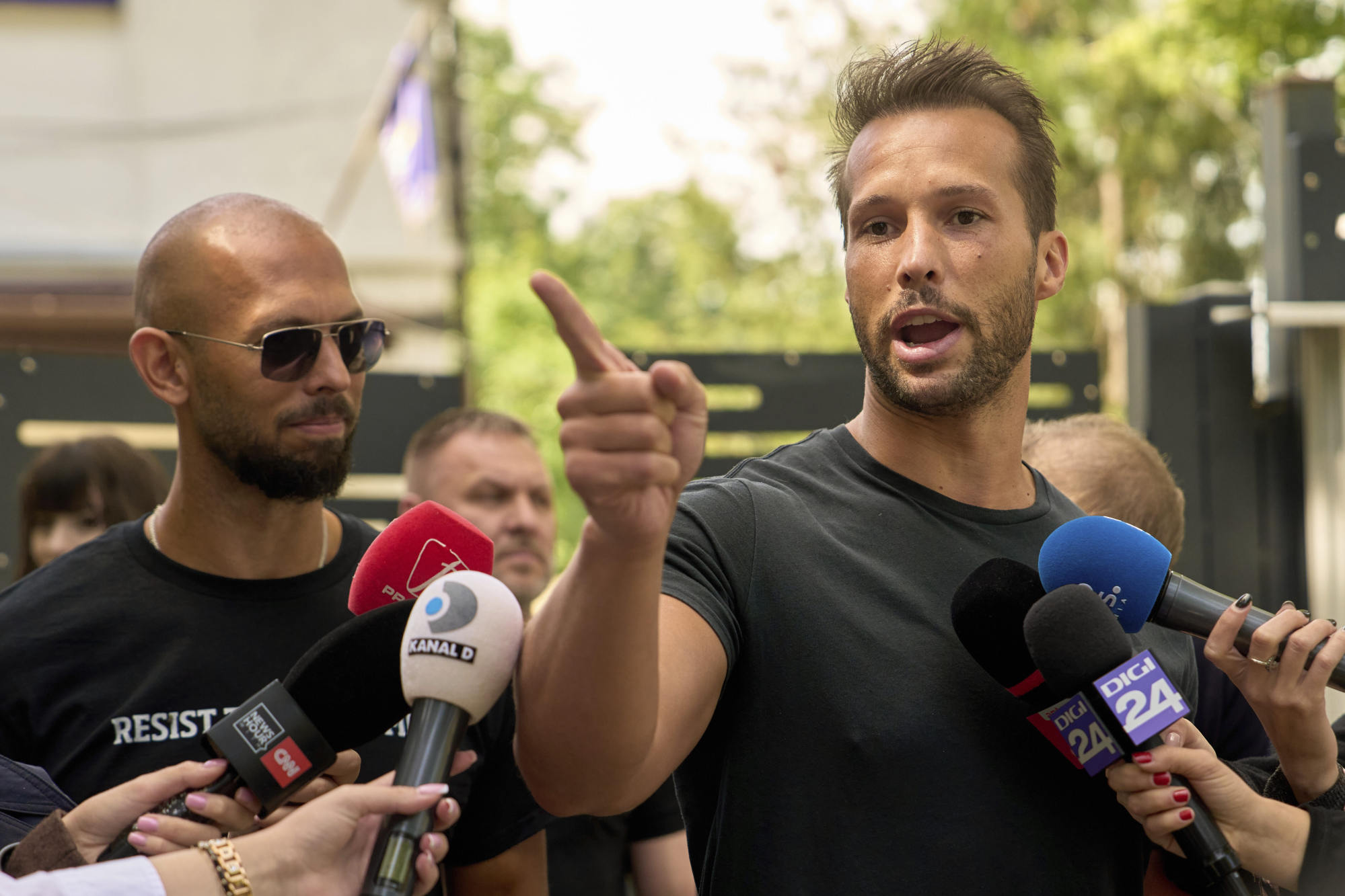 Andrew Tate (left) and his brother Tristan at a media interview outside a police station in Voluntari, Romania last month. Photo: AP Andrew Tate (left) and his brother Tristan at a media interview outside a police station in Voluntari, Romania last month. Photo: AP