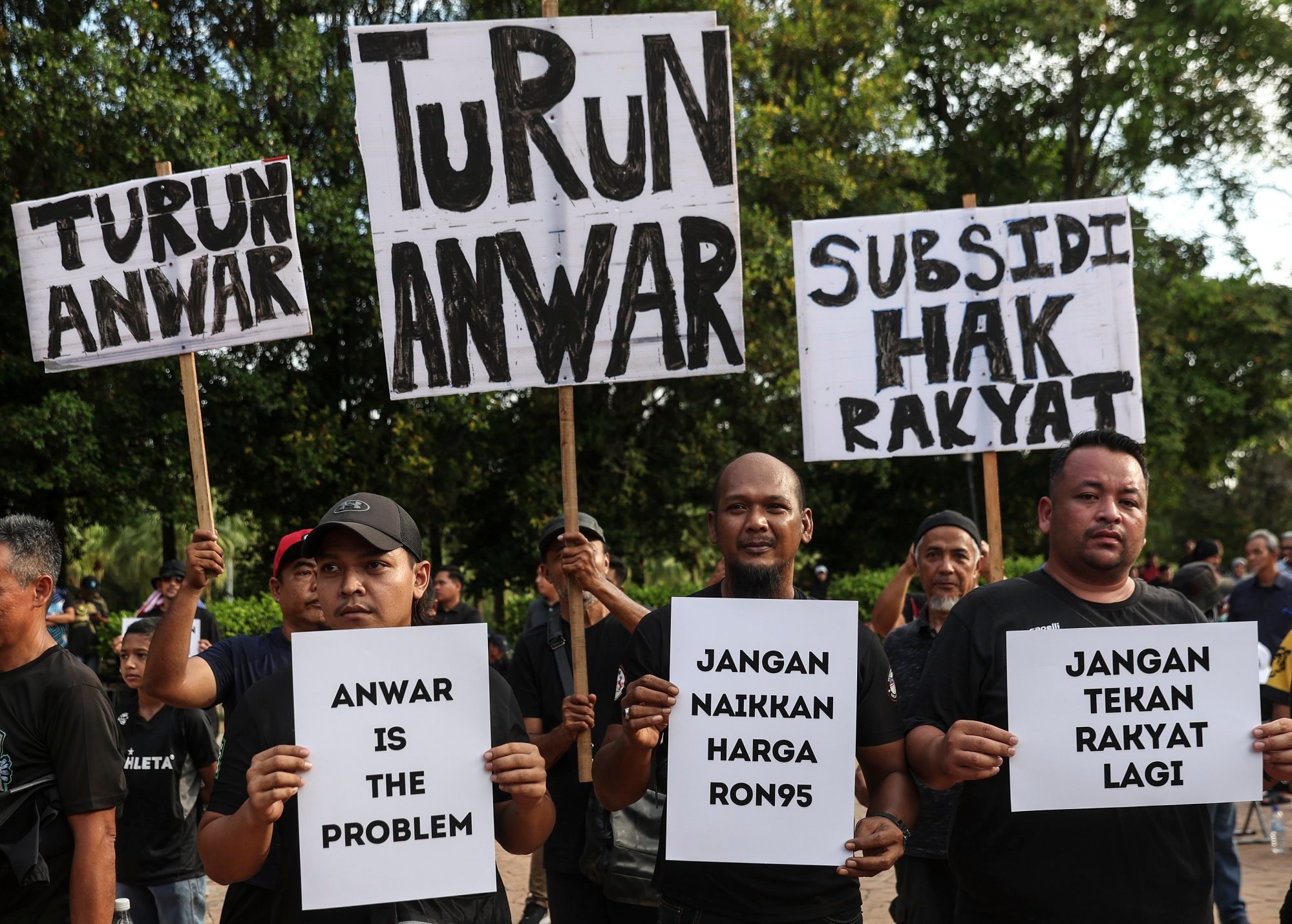 Protesters hold placards outside Malaysian Prime Minister Anwar Ibrahim’s official residence in June last year in a demonstration against subsidy cuts. Photo: EPA-EFE Protesters hold placards outside Malaysian Prime Minister Anwar Ibrahim’s official residence in June last year in a demonstration against subsidy cuts. Photo: EPA-EFE