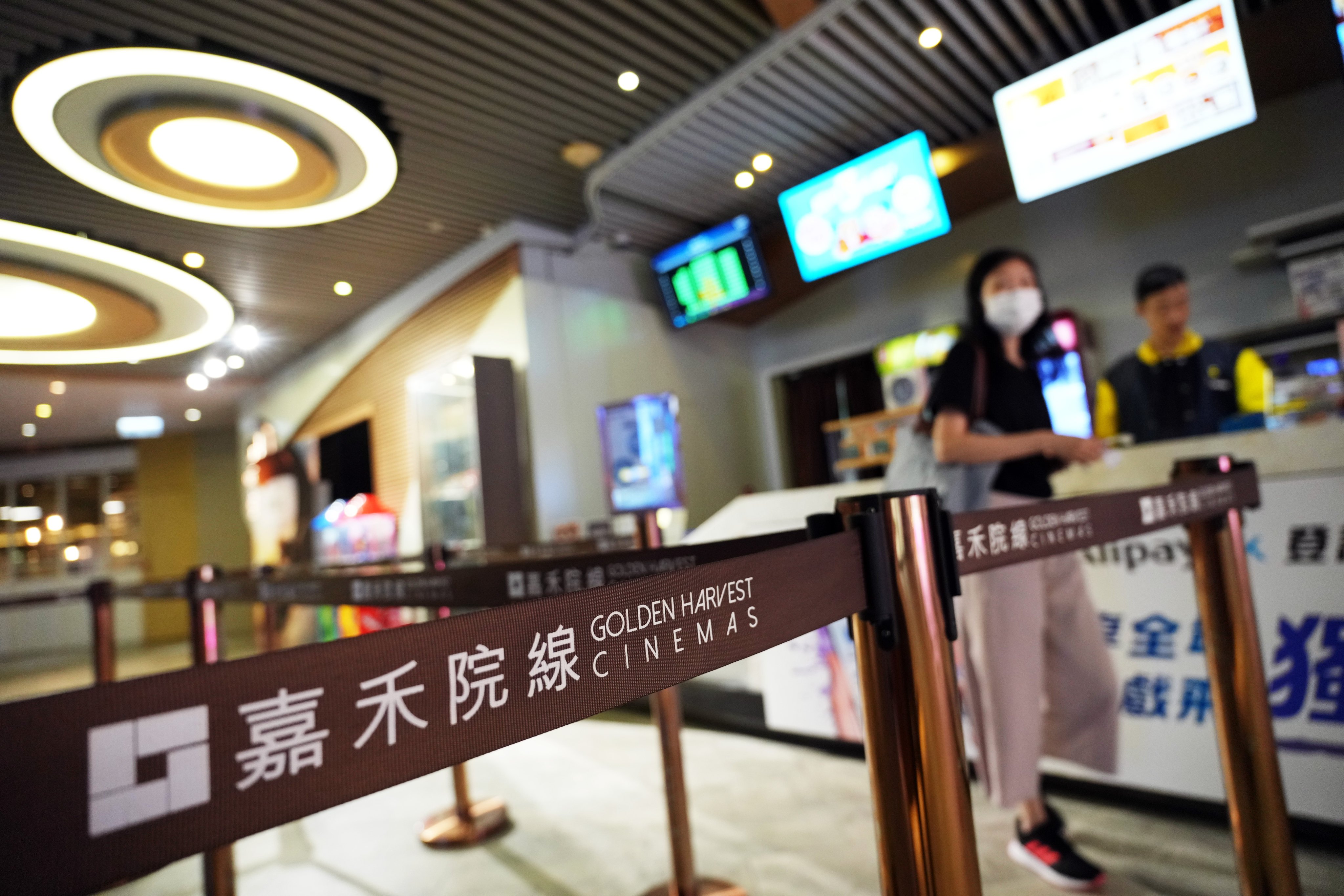 A customer at the ticketing counter of Golden Harvest MegaBox in Kowloon Bay on Wednesday, ahead of its closure on Sunday. Photo: Sam Tsang